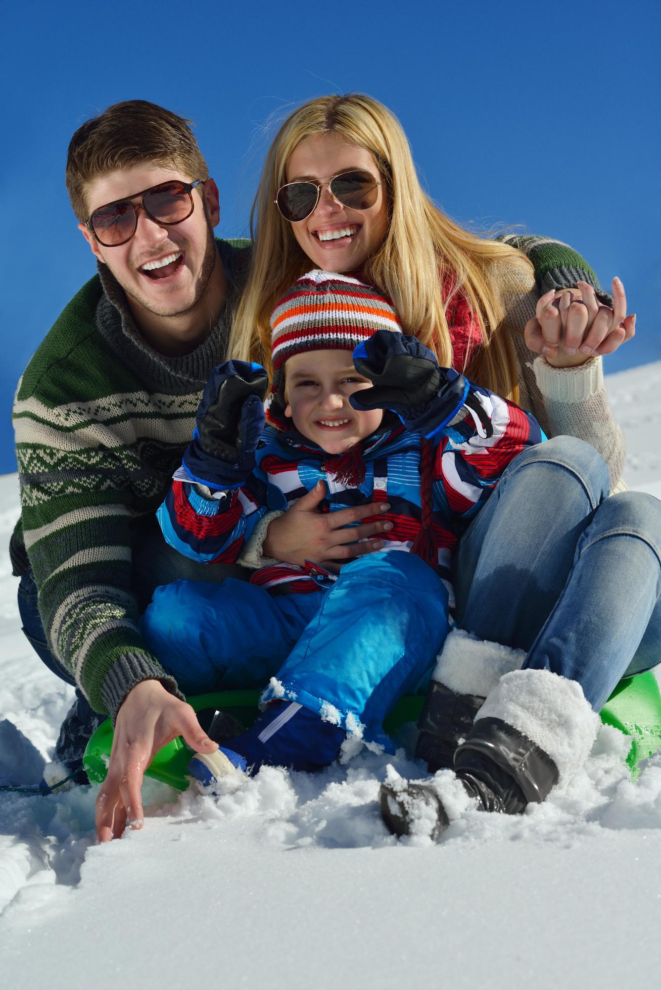 family having fun on fresh snow at winter Stock Free