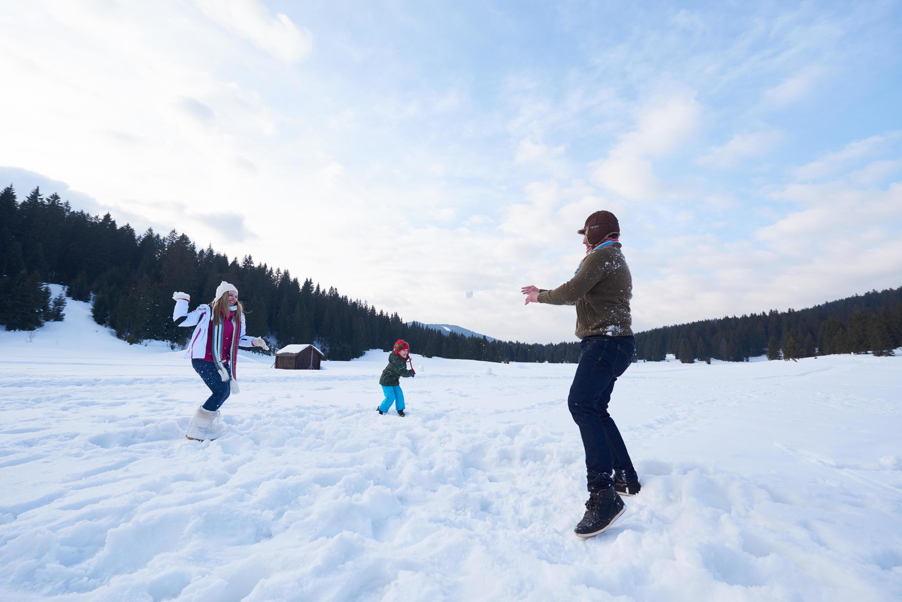 happy family playing together in snow at winter Stock Free