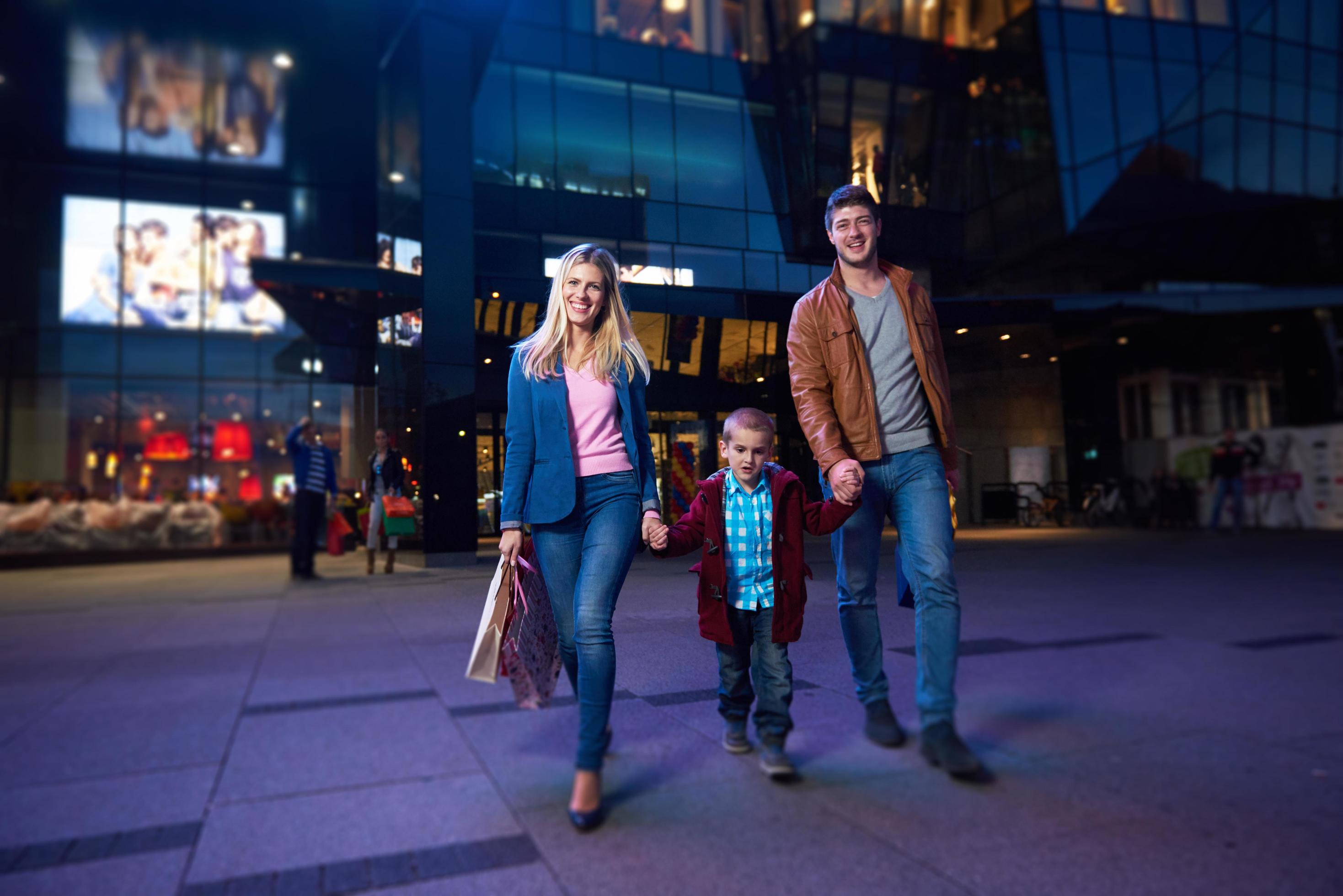 happy family walking with shopping bag Stock Free