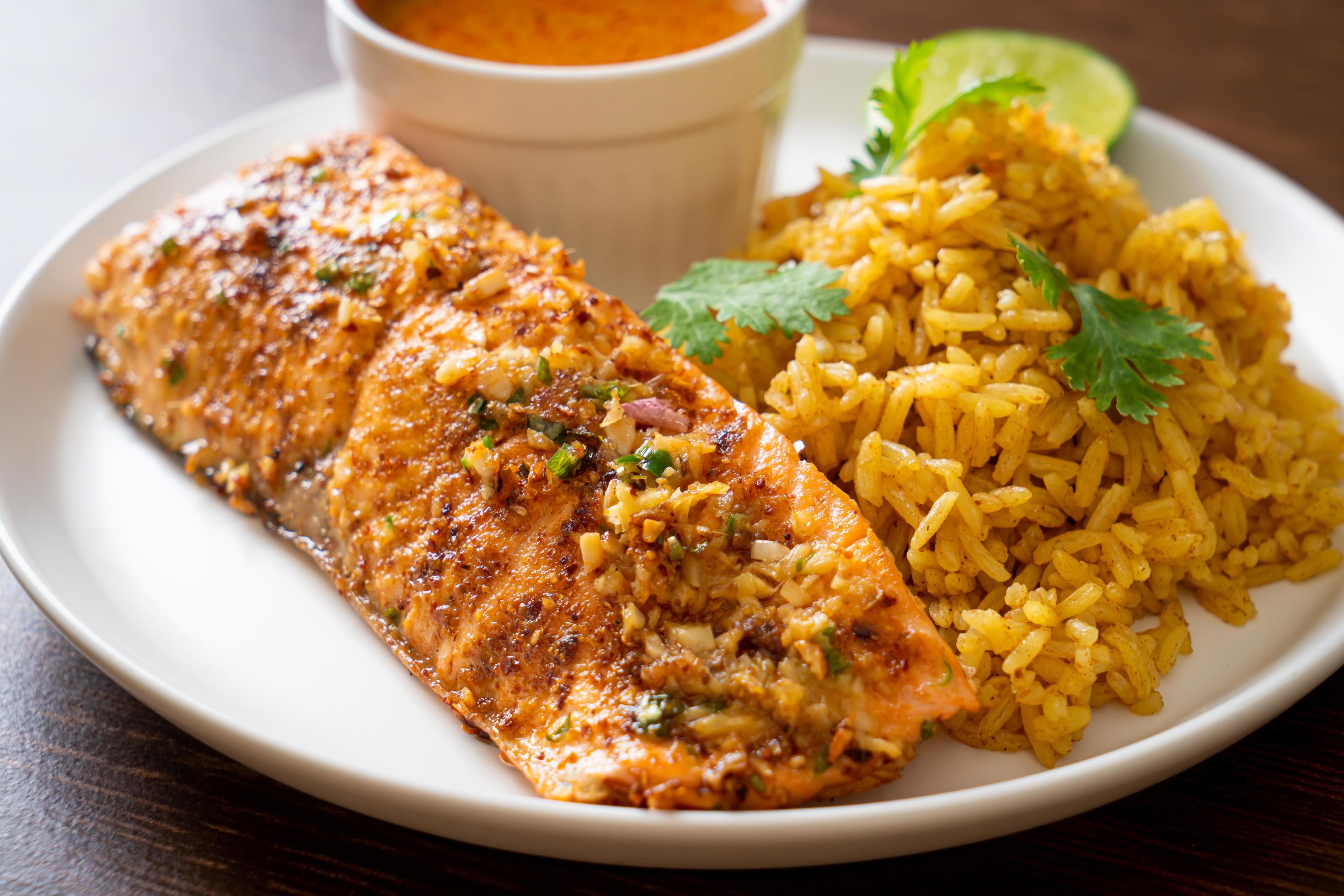 Pan-seared salmon tandoori with masala rice – Muslim food style Stock Free