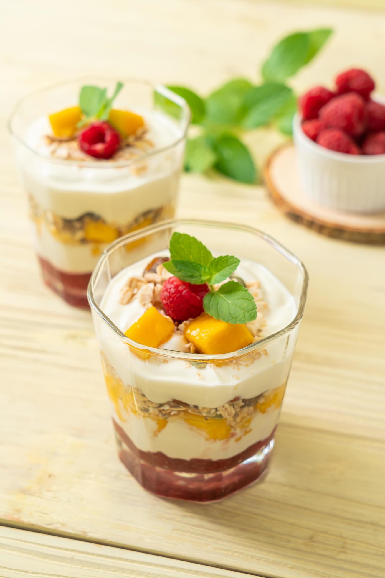 Homemade fresh mango and fresh raspberry with yogurt and granola – healthy food style Stock Free