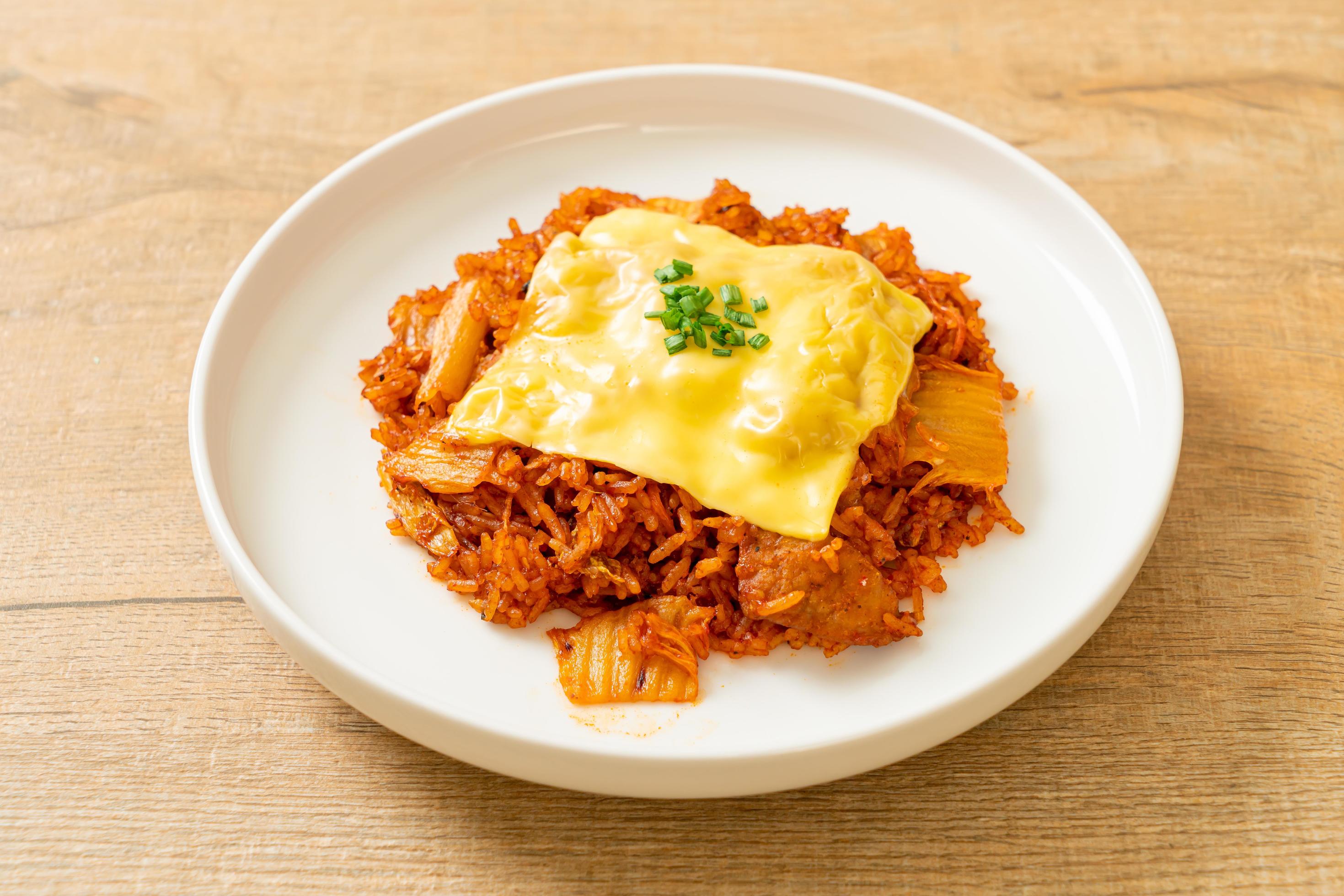 Kimchi fried rice with pork and topped cheese – Asian and fusion food style Stock Free