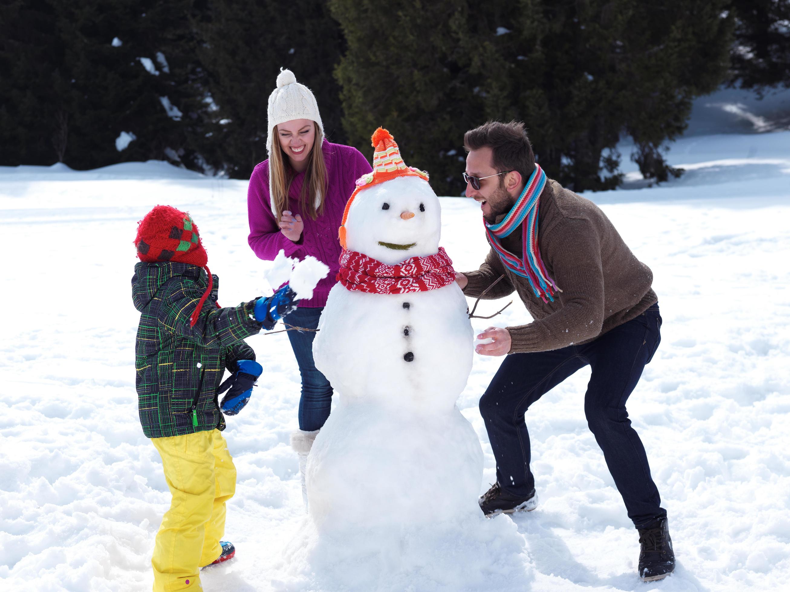 happy family making snowman Stock Free