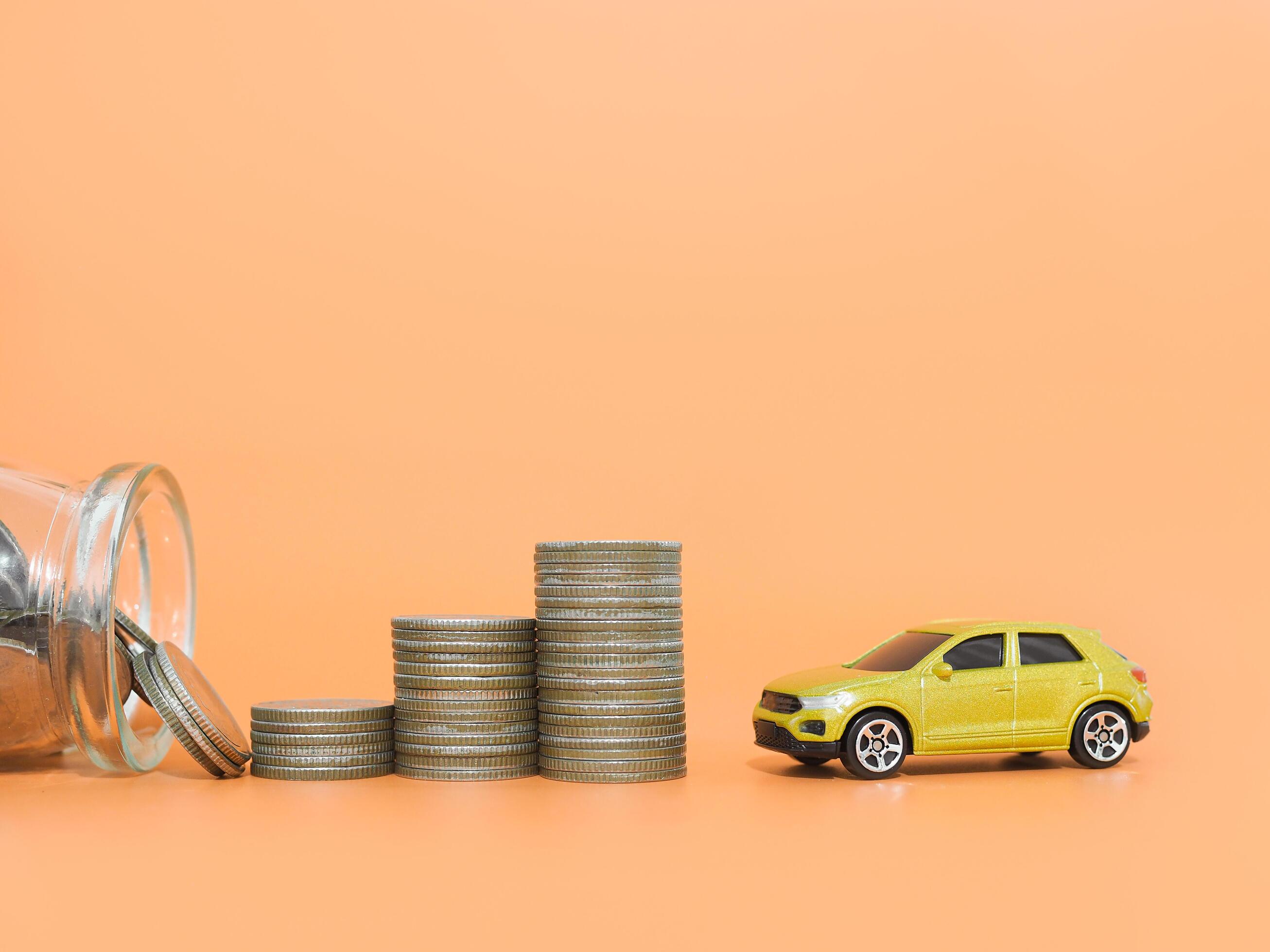 Toy cars and stack of coins. The concept of saving money and manage to success transport business Stock Free