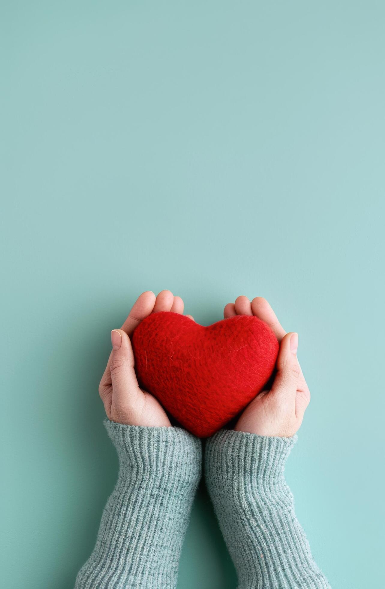 Hands Holding Red Heart on Blue Background Stock Free