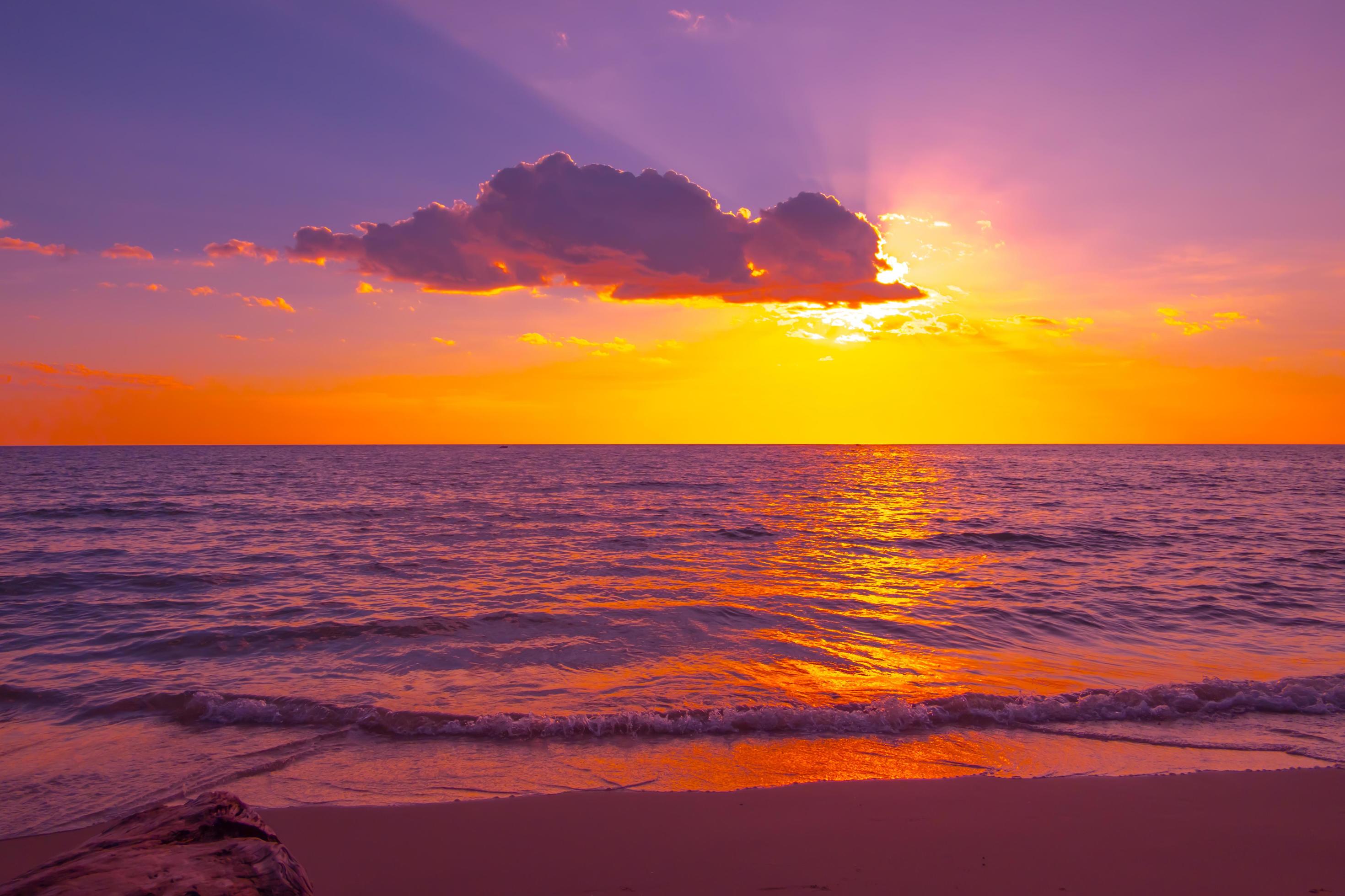 Beautiful sunset over the sea on the tropical beach with sky and clouds for travel in holiday relax time Stock Free