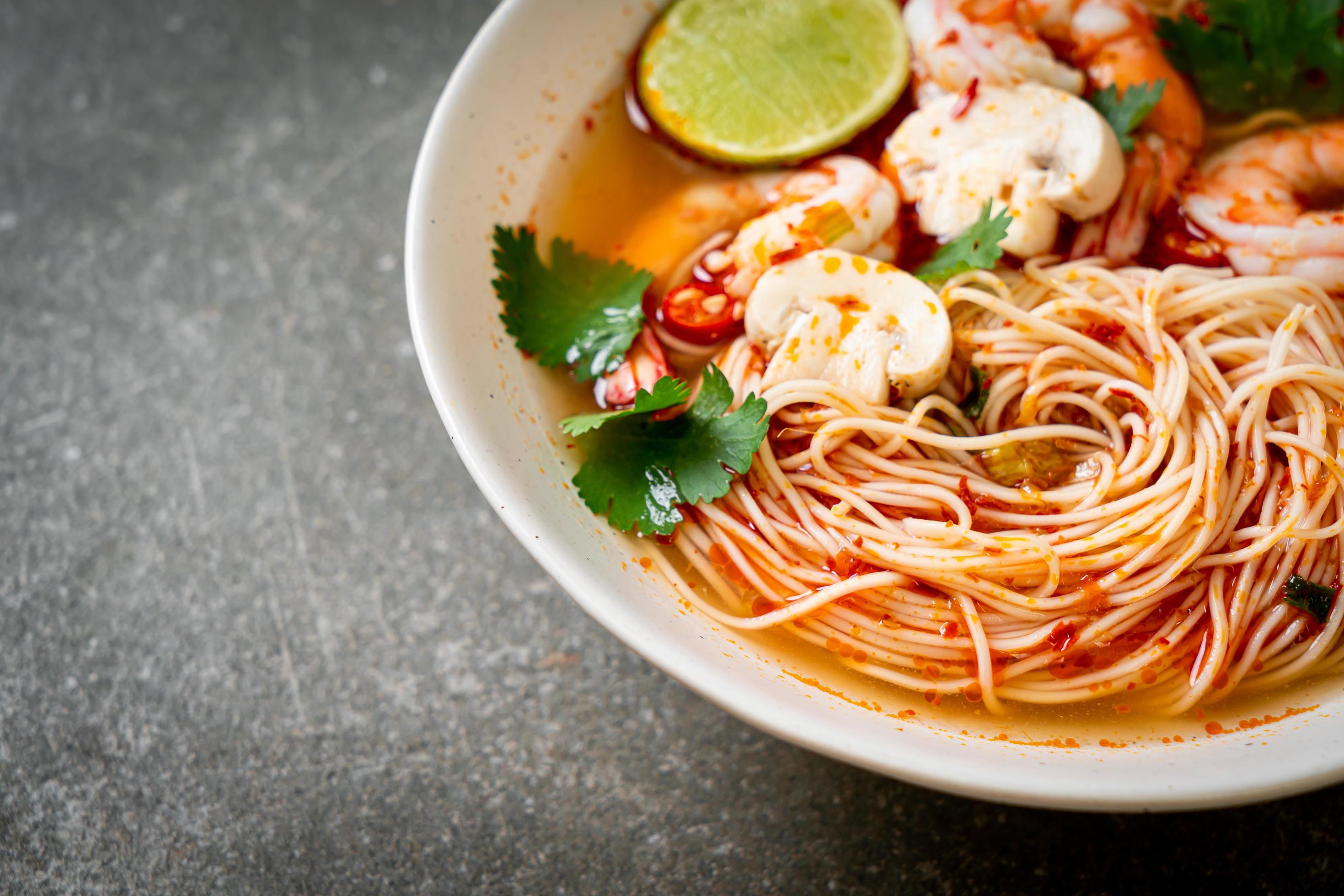 Noodles with spicy soup and shrimps or Tom Yum Kung – Asian food style Stock Free