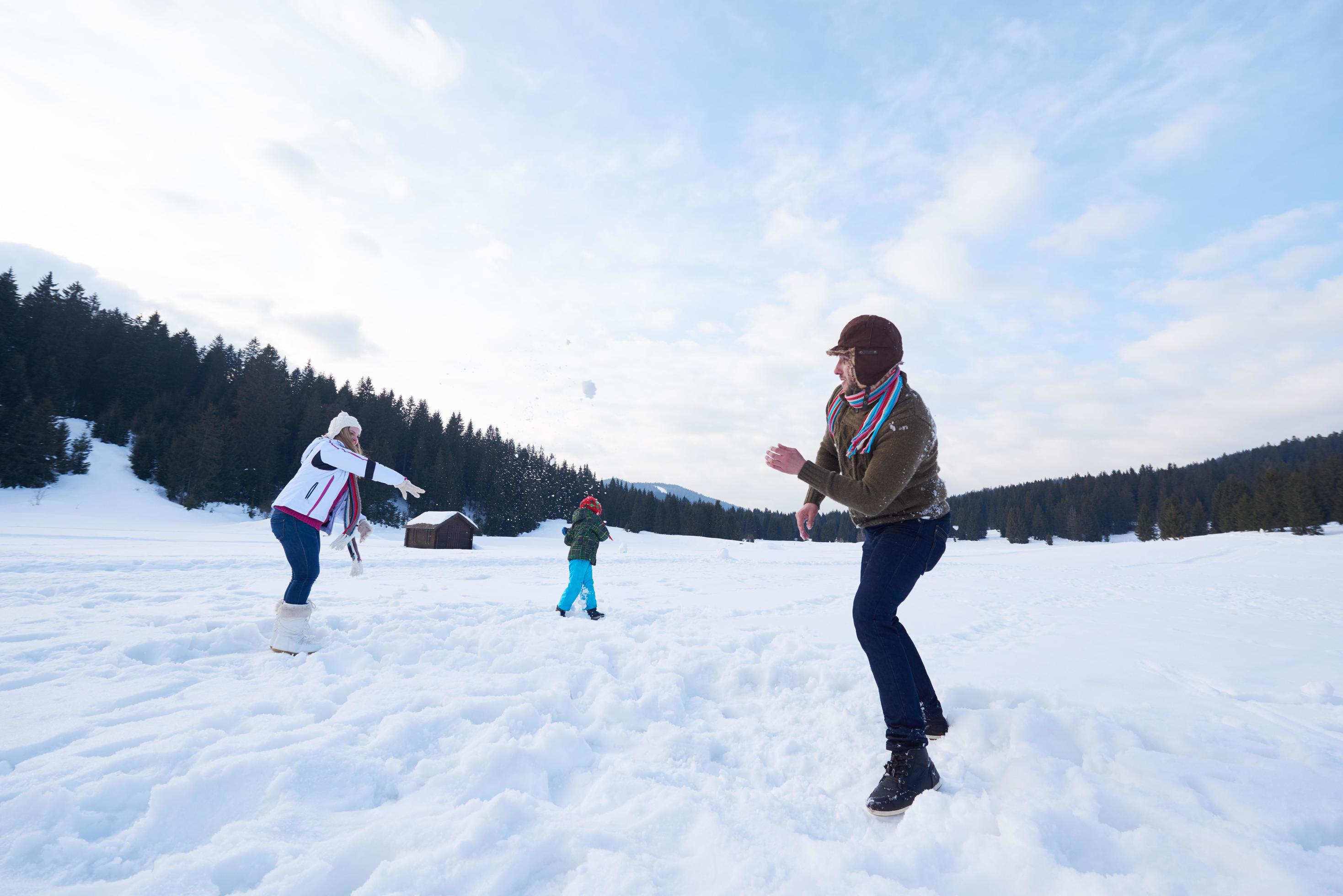 happy family playing together in snow at winter Stock Free