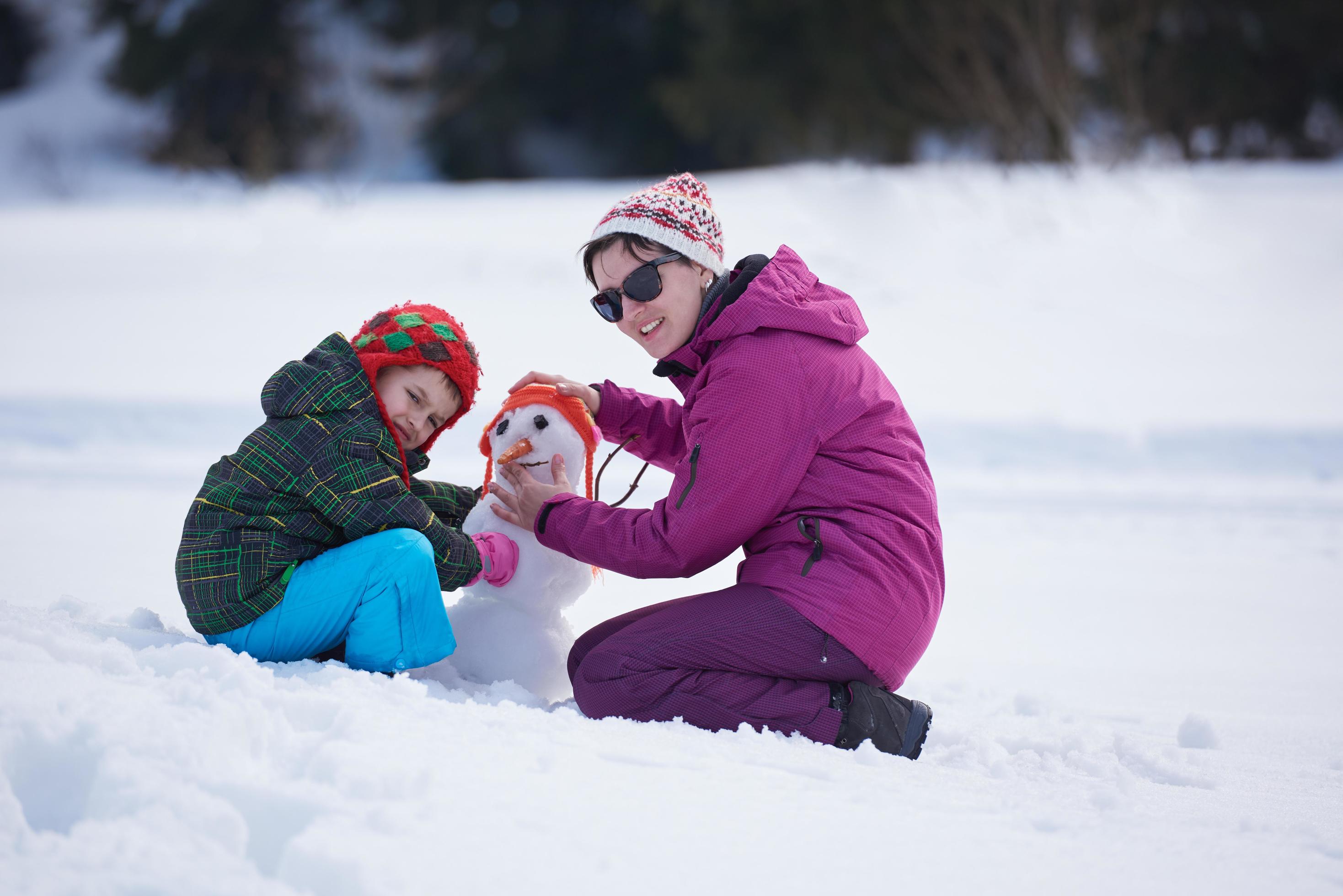 happy family building snowman Stock Free