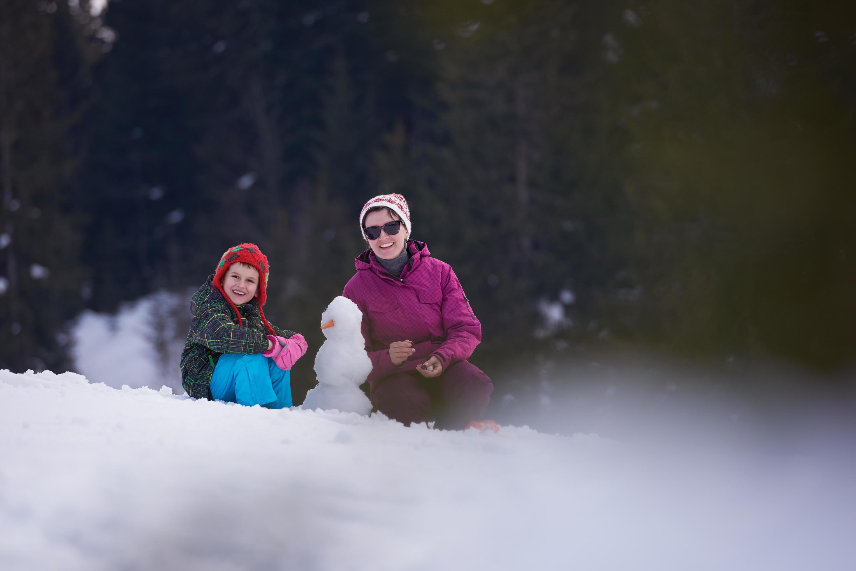 happy family building snowman Stock Free