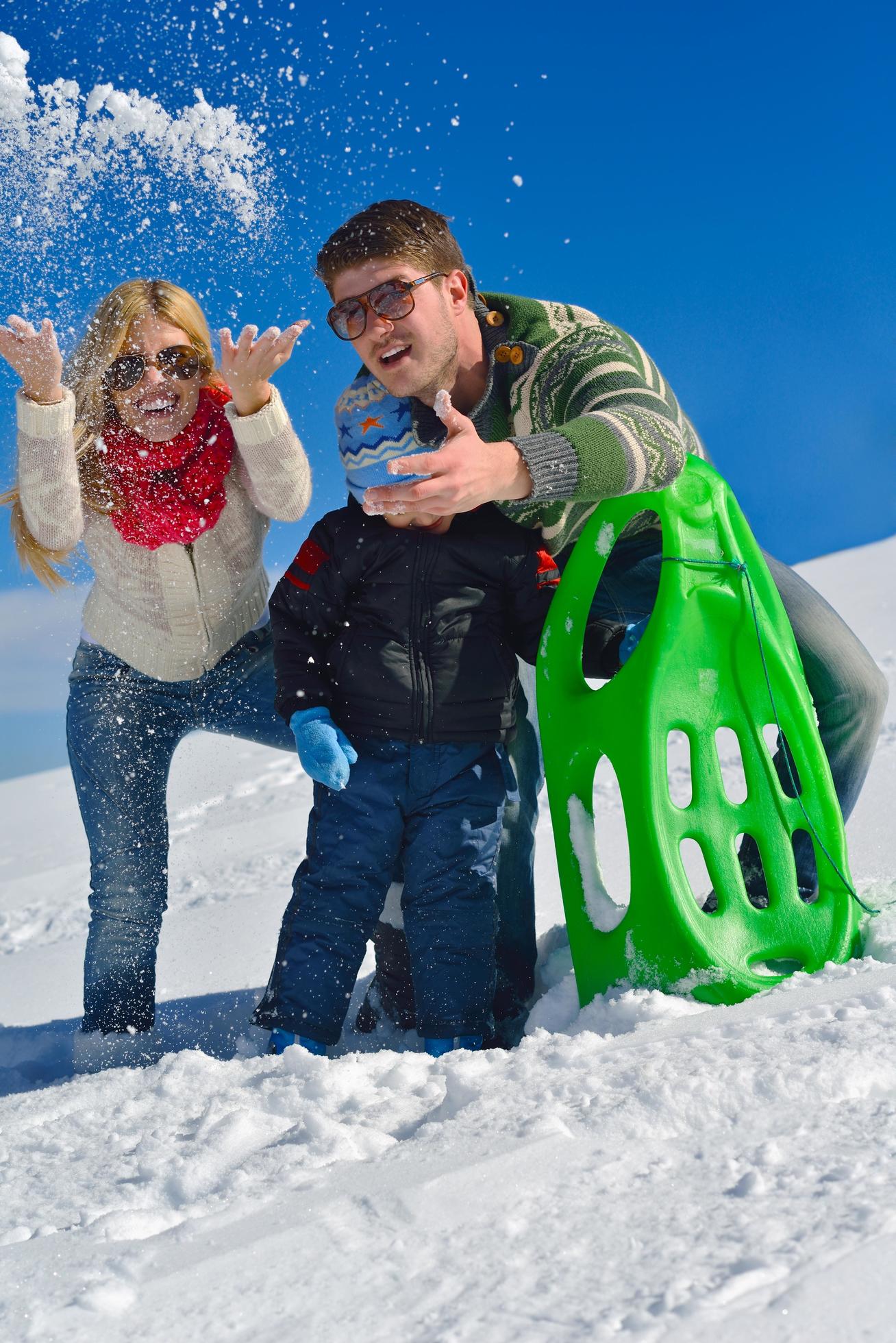 family having fun on fresh snow at winter Stock Free