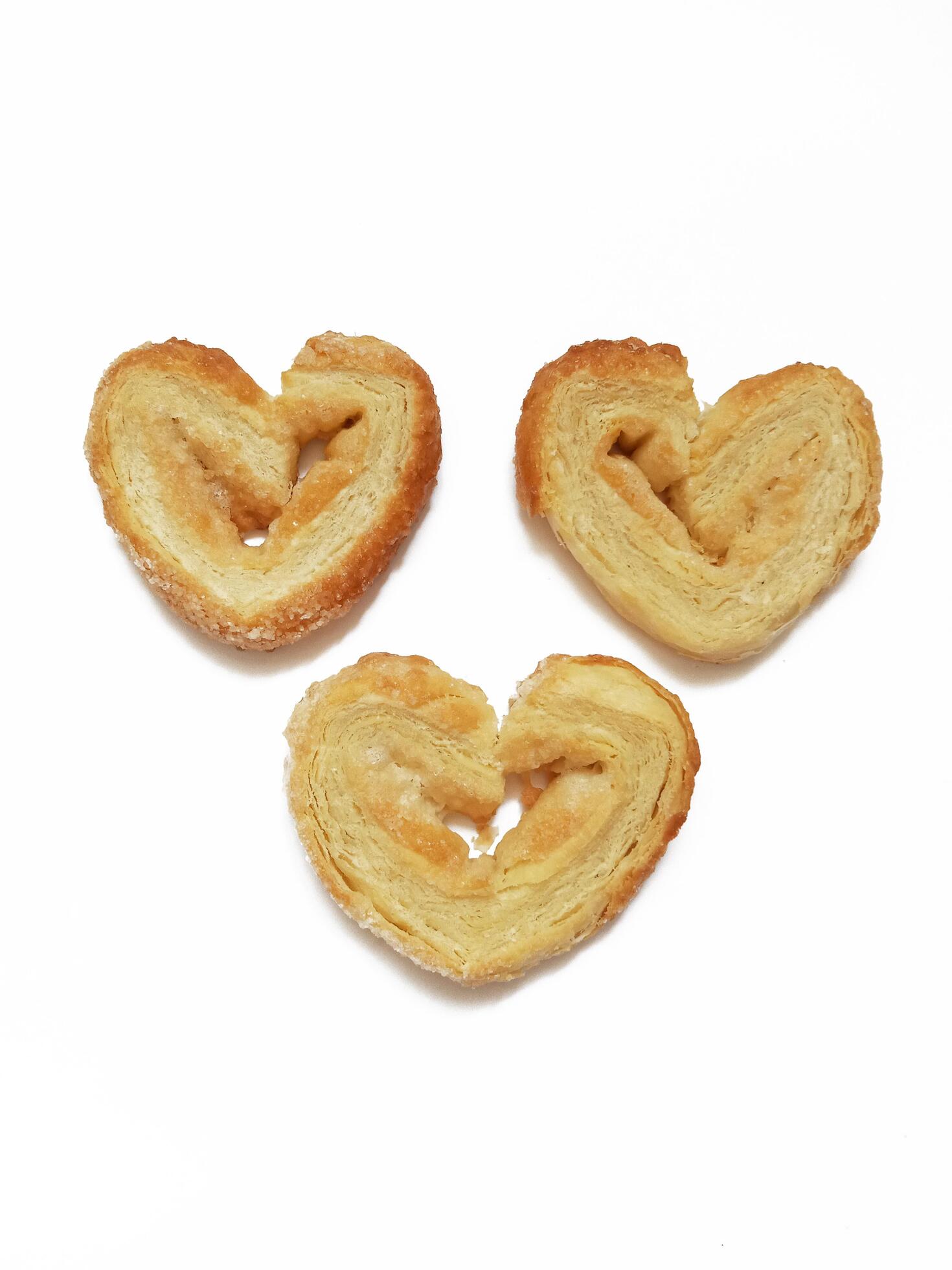 Sugar cookie curls puff pastry heart shape on white background Stock Free