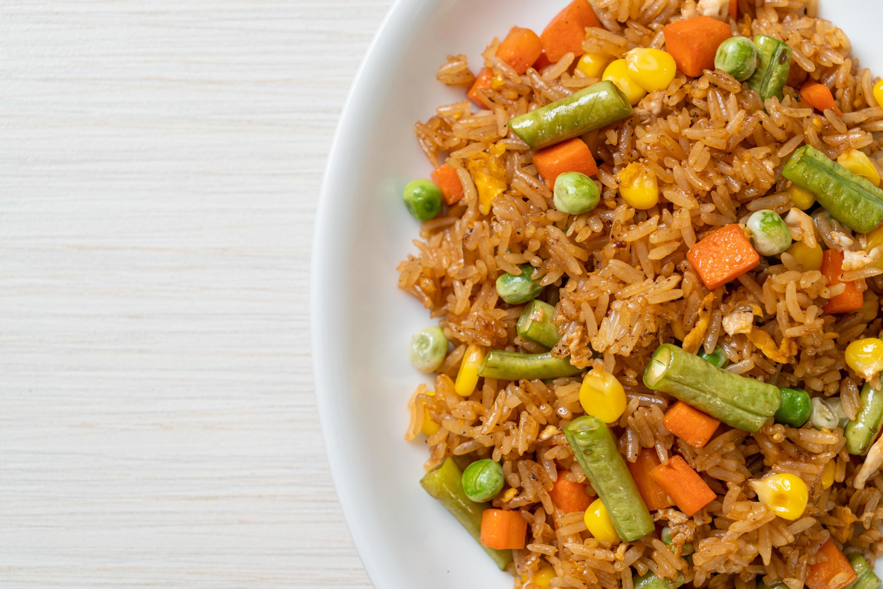 Fried rice with green peas, carrot and corn – vegetarian and healthy food style Stock Free