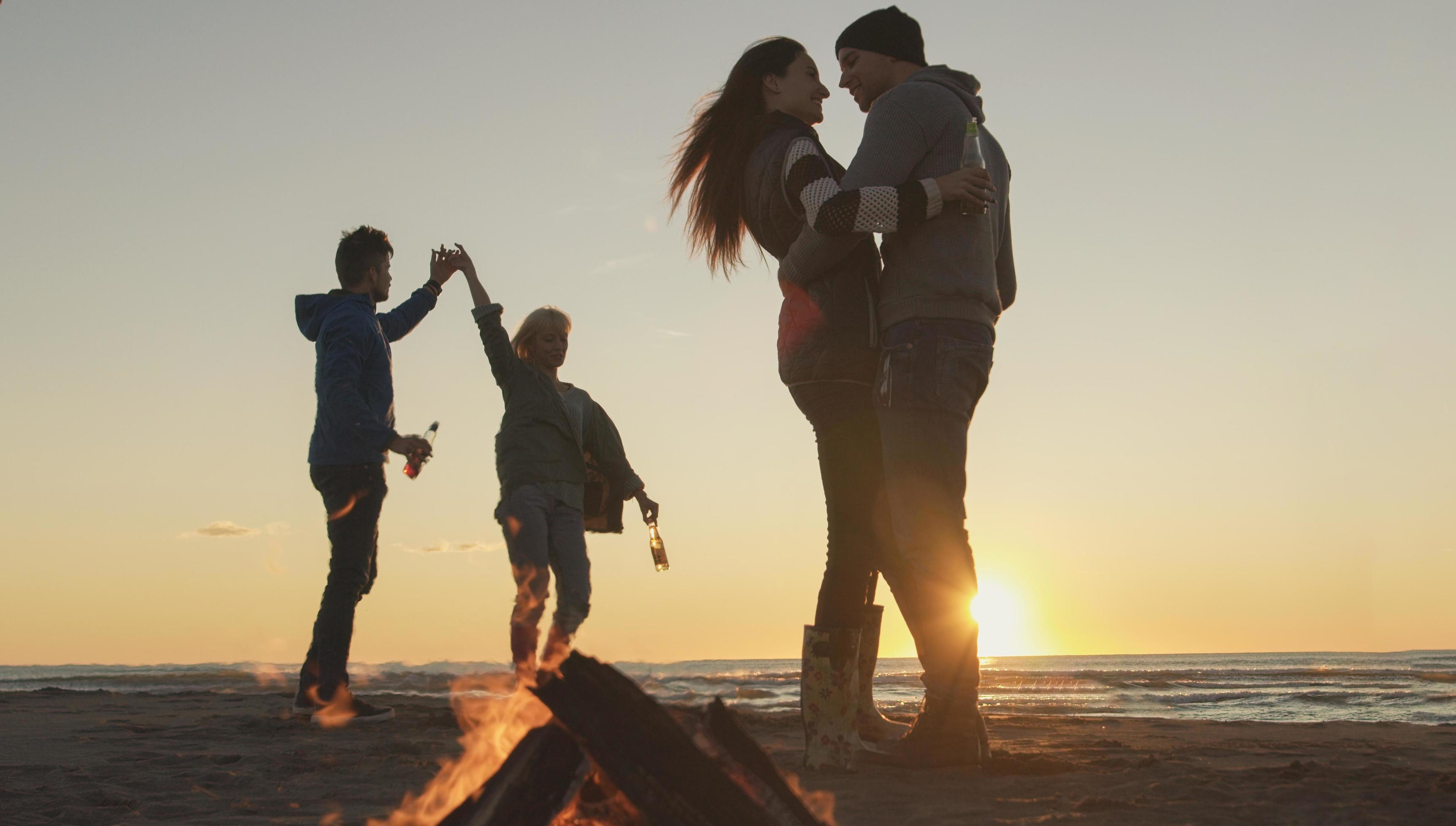 Friends having fun at beach on autumn day Stock Free