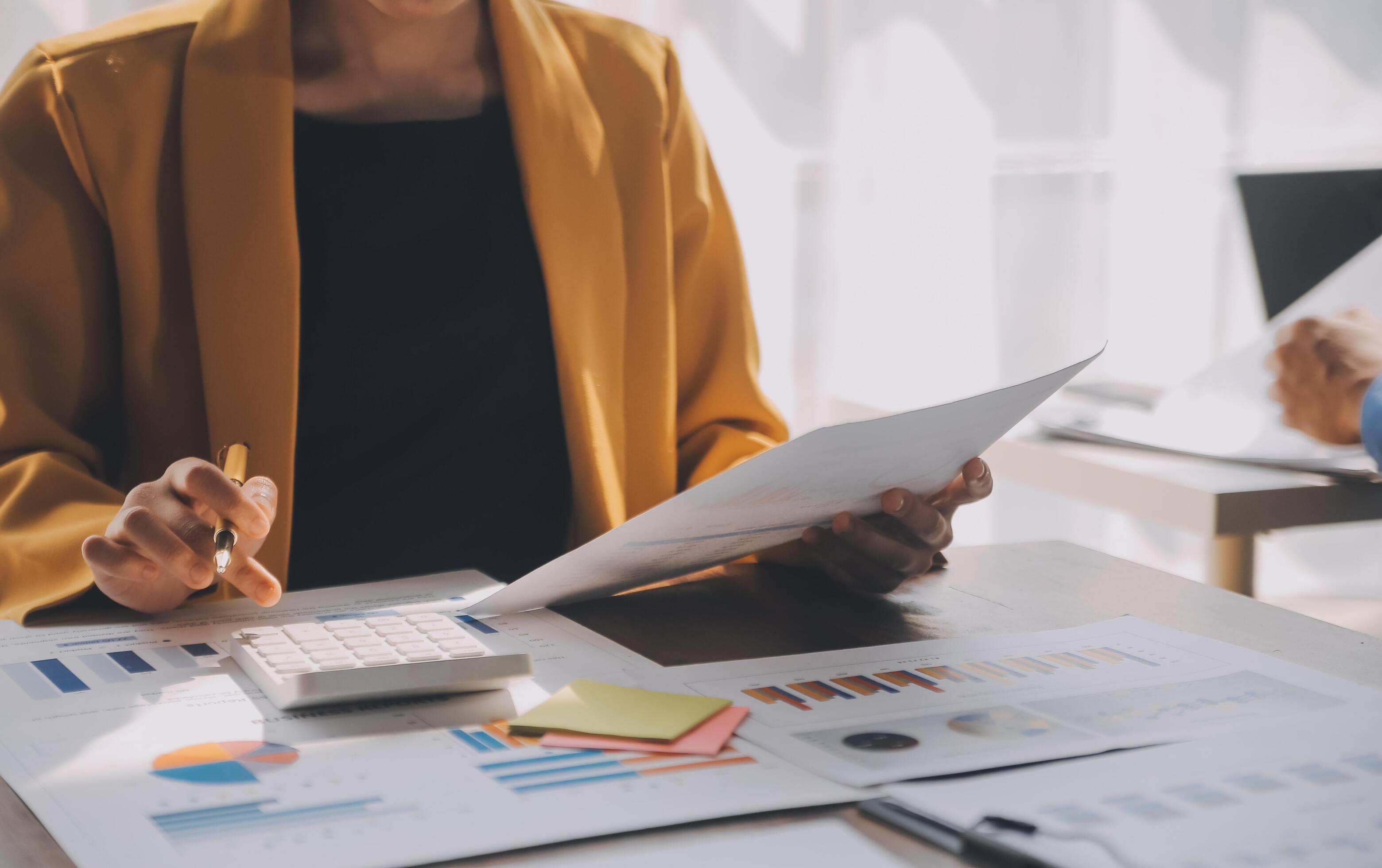 Close up of Business team analyzing income charts and graphs with modern laptop computer. Business analysis and strategy concept. Stock Free