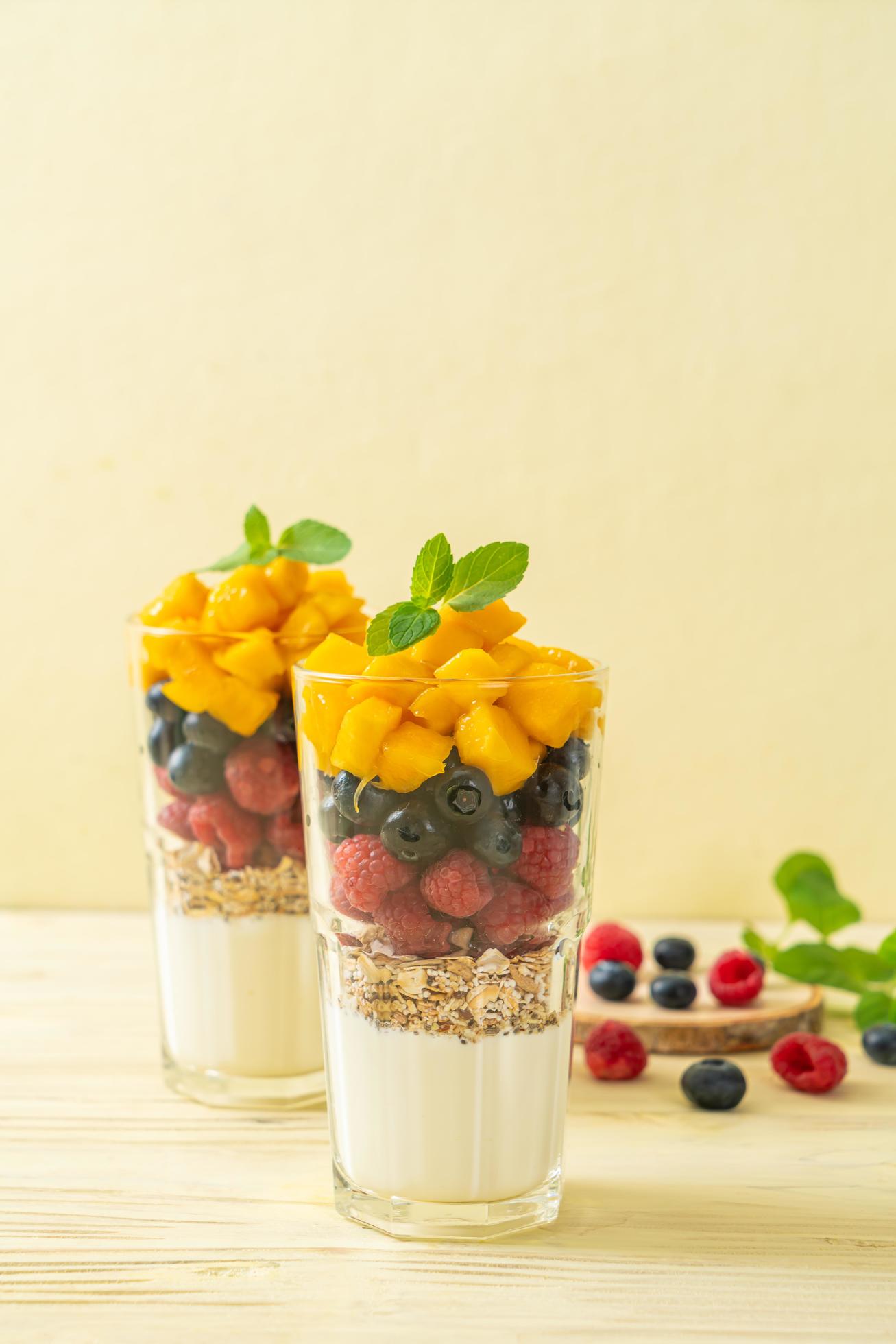 Homemade fresh mango and fresh raspberry with yogurt and granola – healthy food style Stock Free