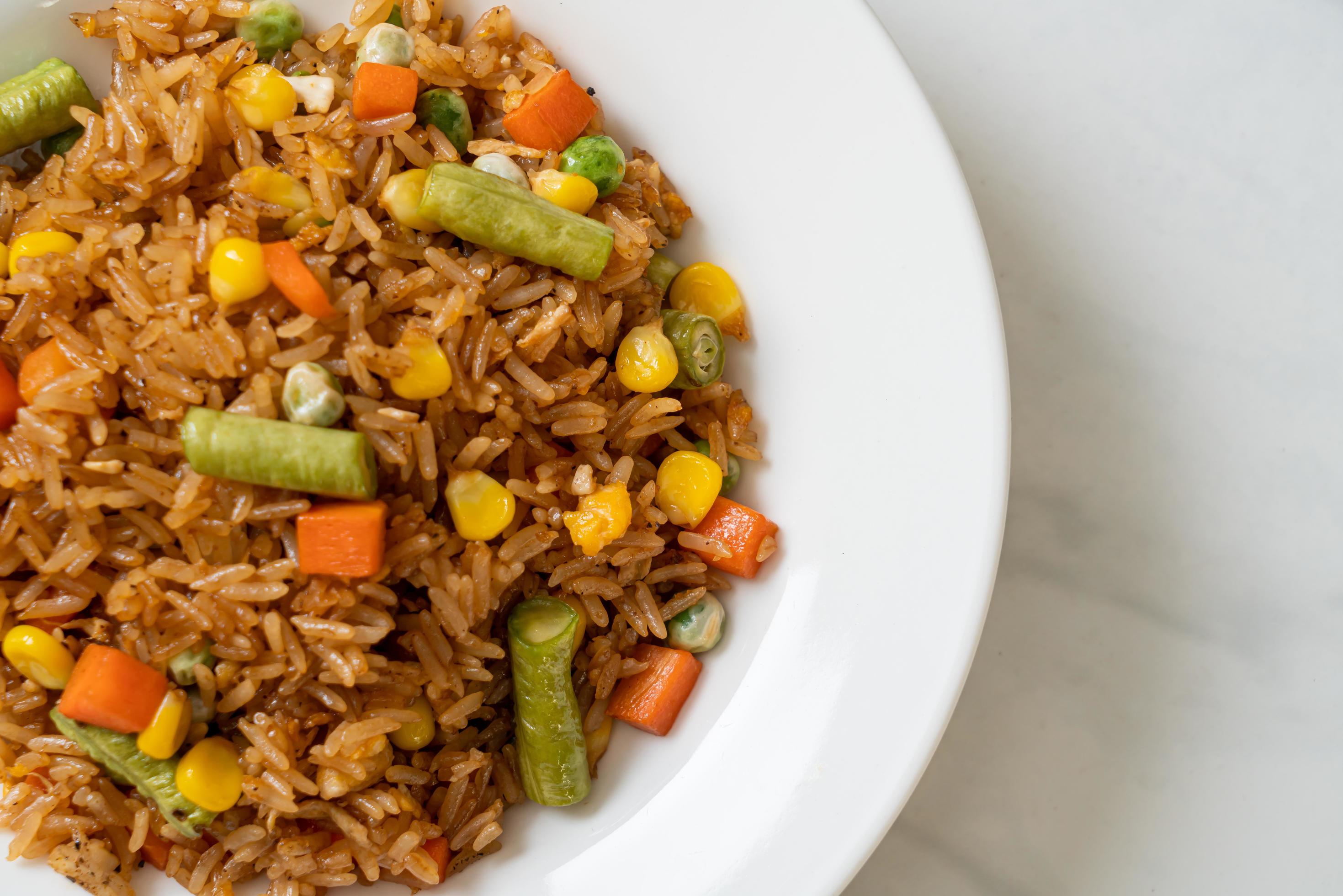 Fried rice with green peas, carrot and corn – vegetarian and healthy food style Stock Free