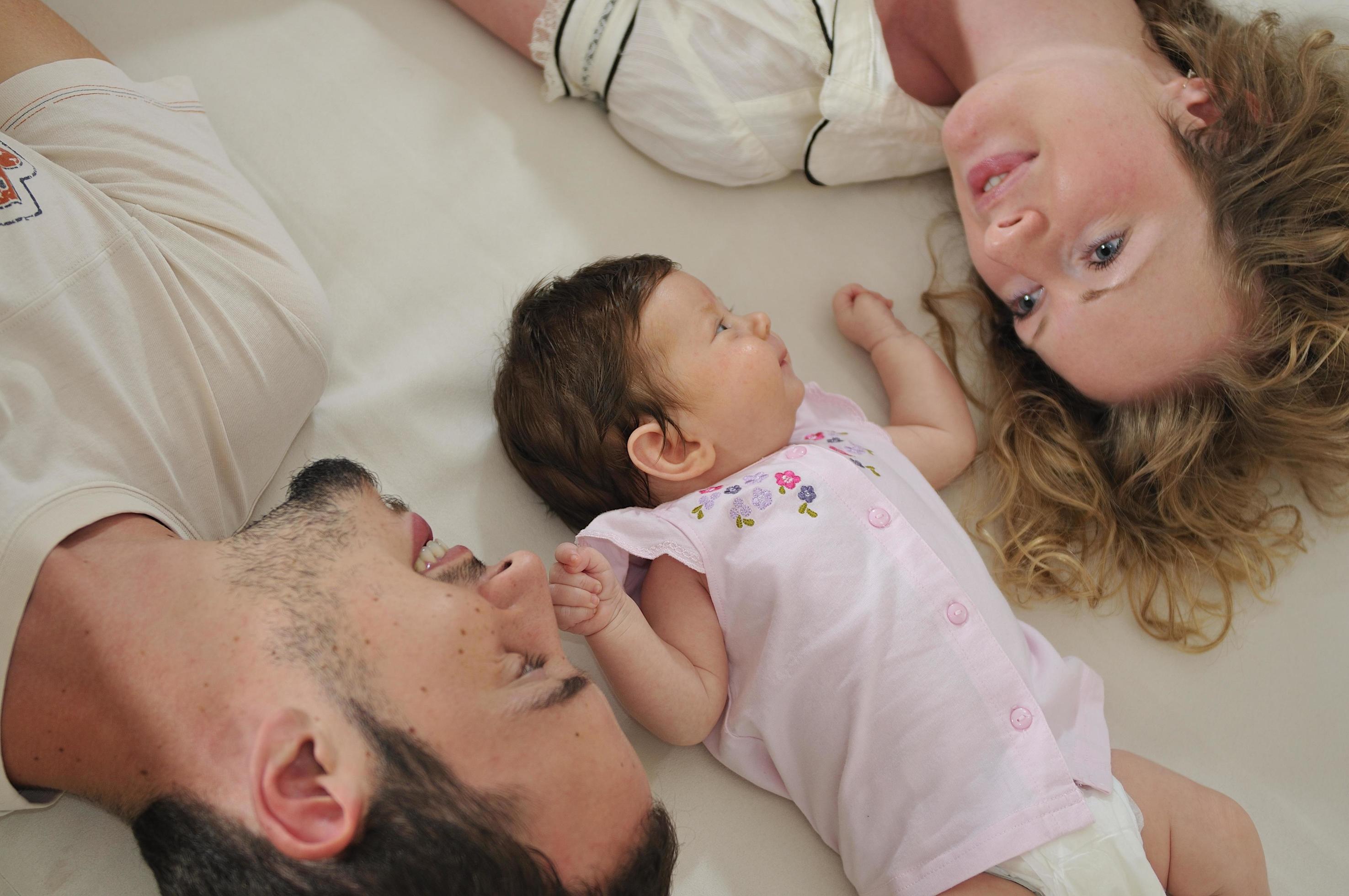 young family playing with cute little baby Stock Free