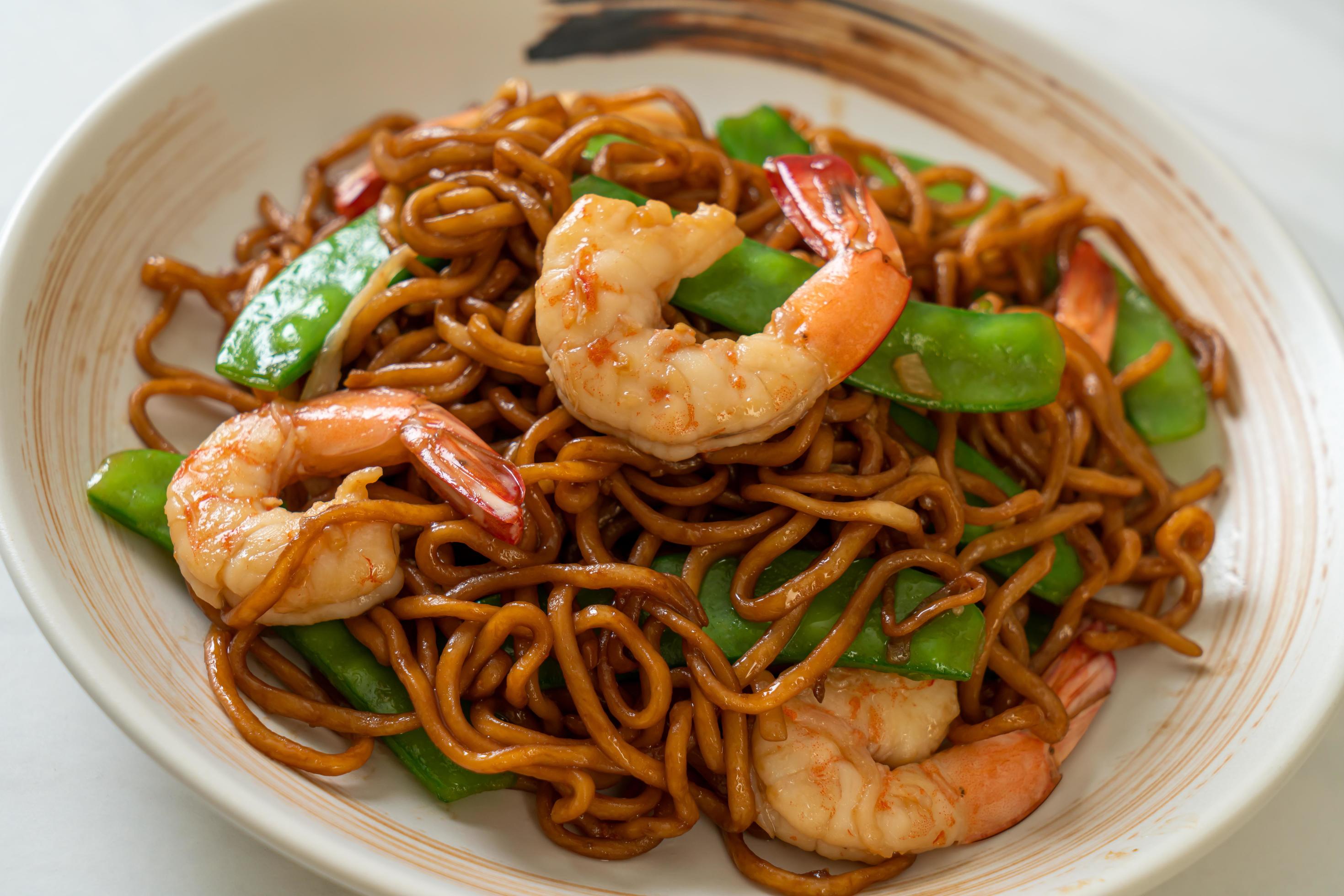 Stir-fried yakisoba noodles with green peas and shrimps – Asian food style Stock Free