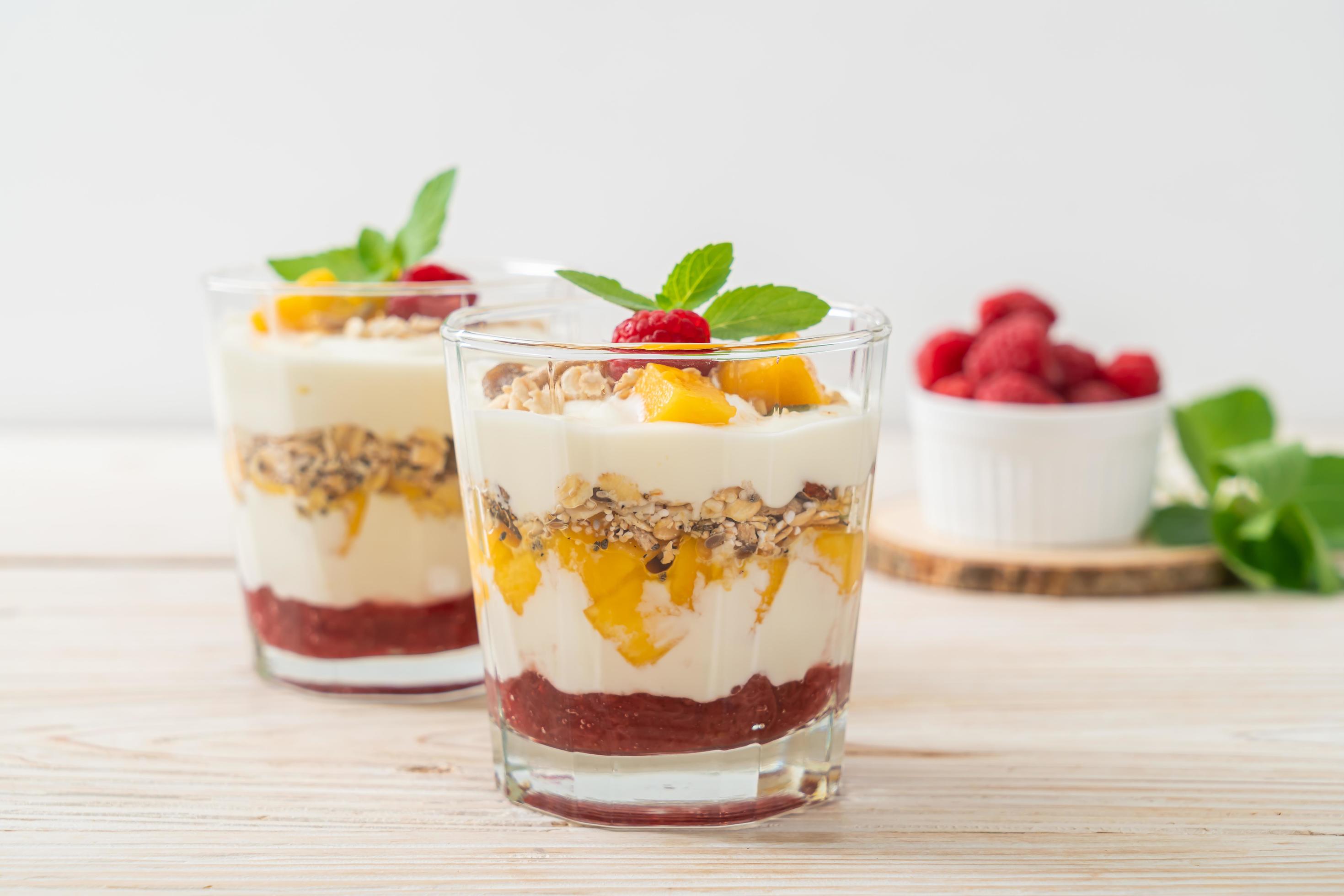 Homemade fresh mango and fresh raspberry with yogurt and granola – healthy food style Stock Free