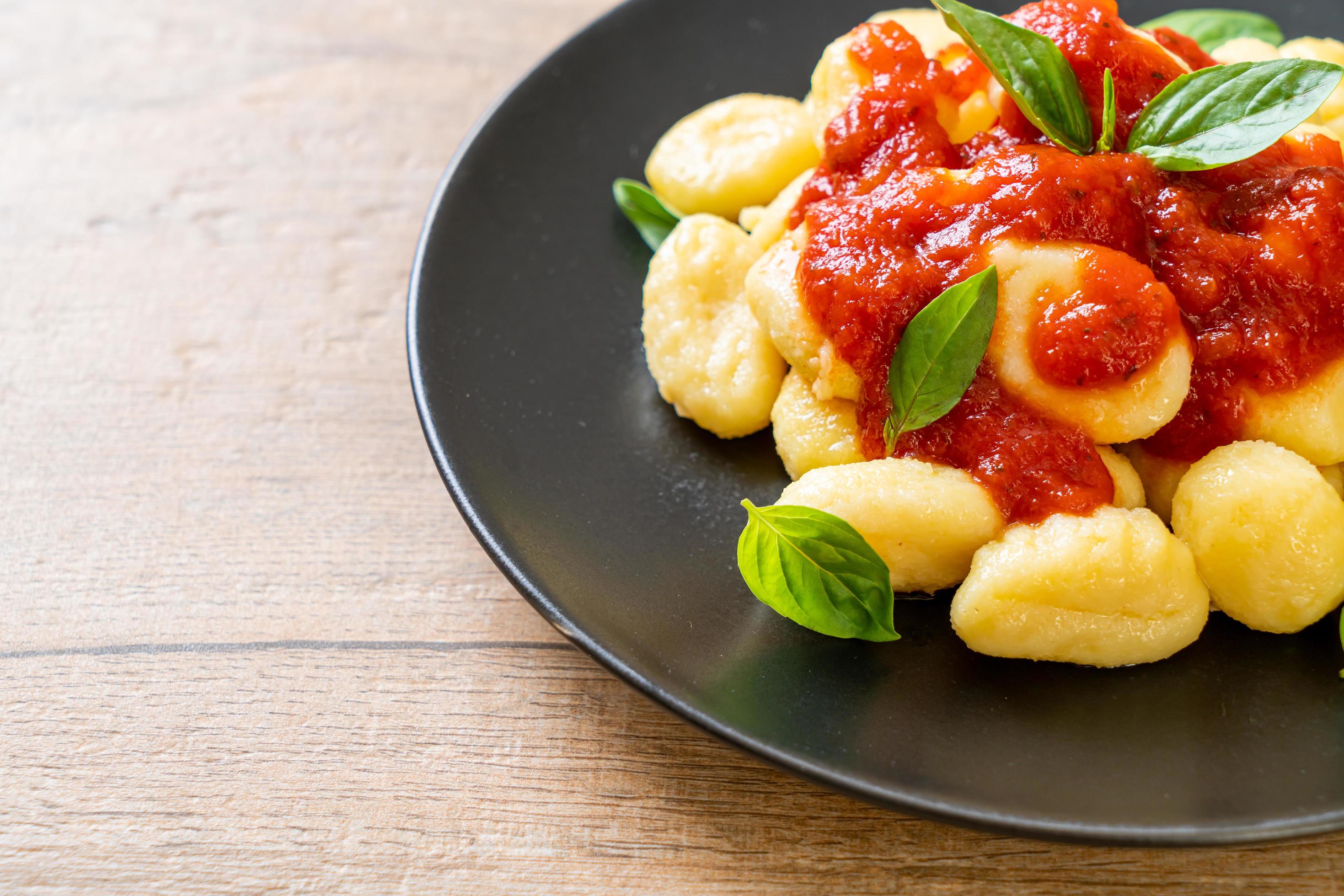 Gnocchi in tomato sauce with cheese – Italian food style Stock Free