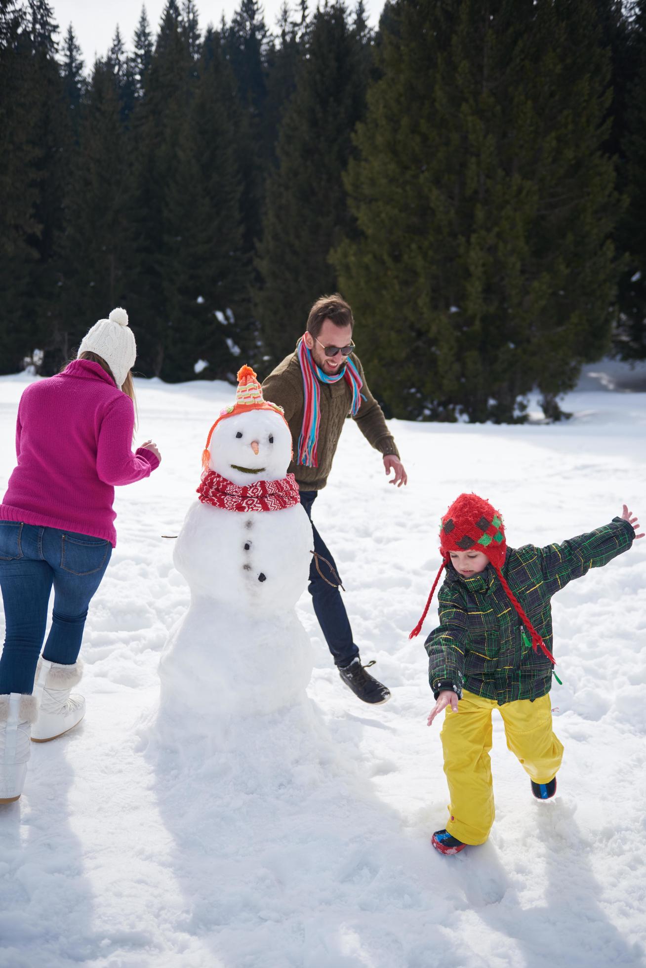 happy family building snowman Stock Free