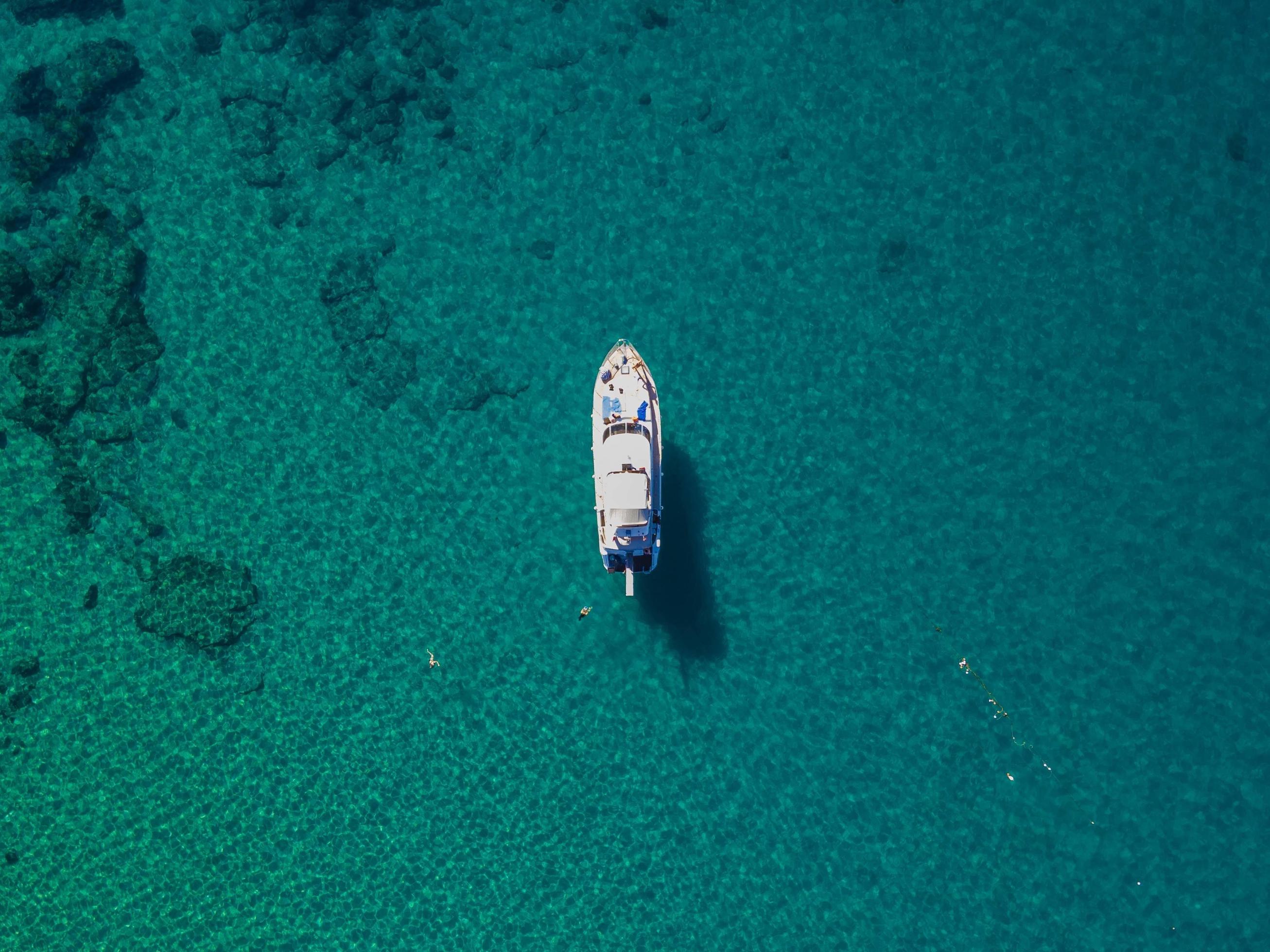 aerial sea and boat. bird’s eye view over the blue sea. amazing view of the blue sea Stock Free