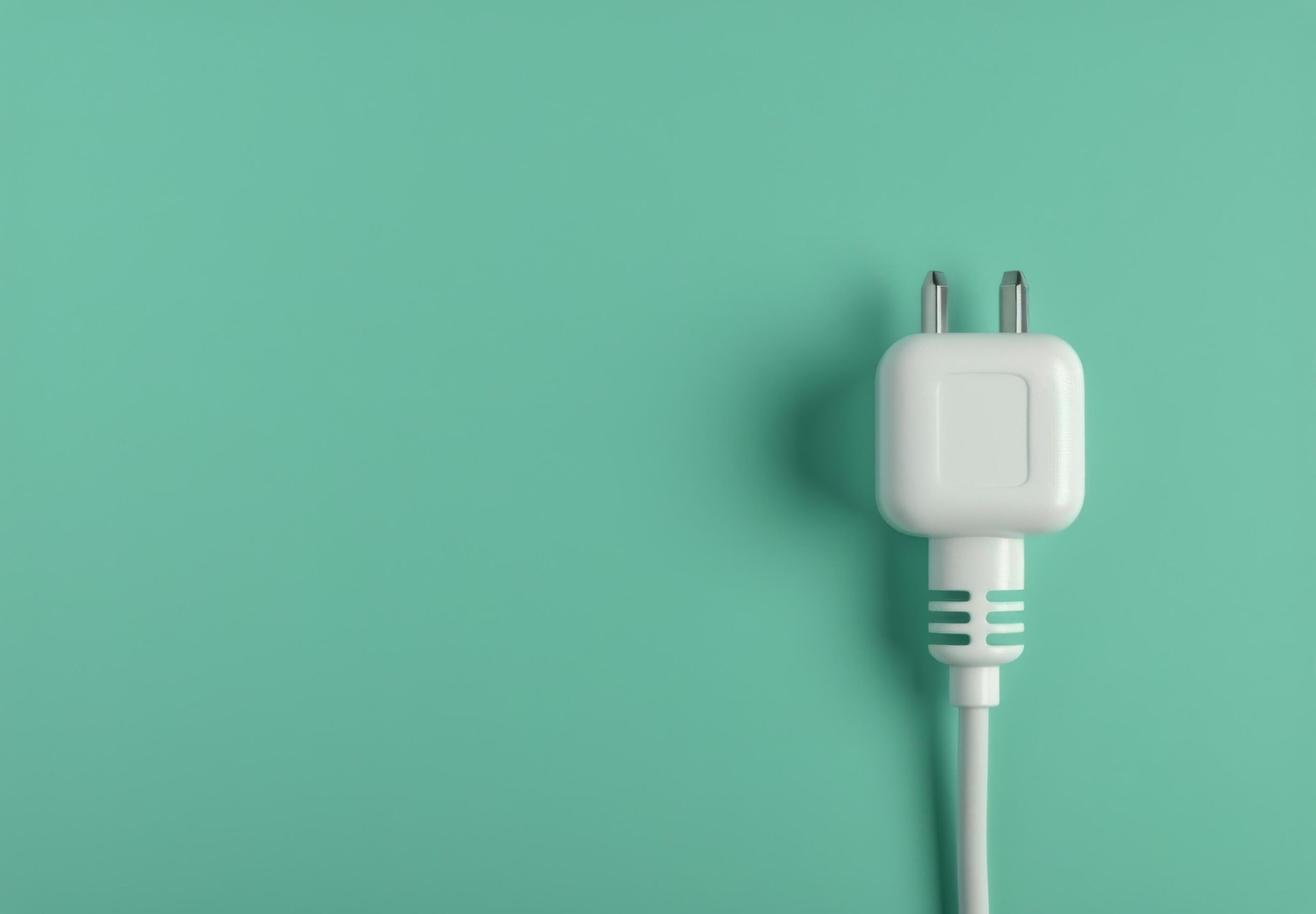 Two White Electrical Plugs on Teal Background Stock Free