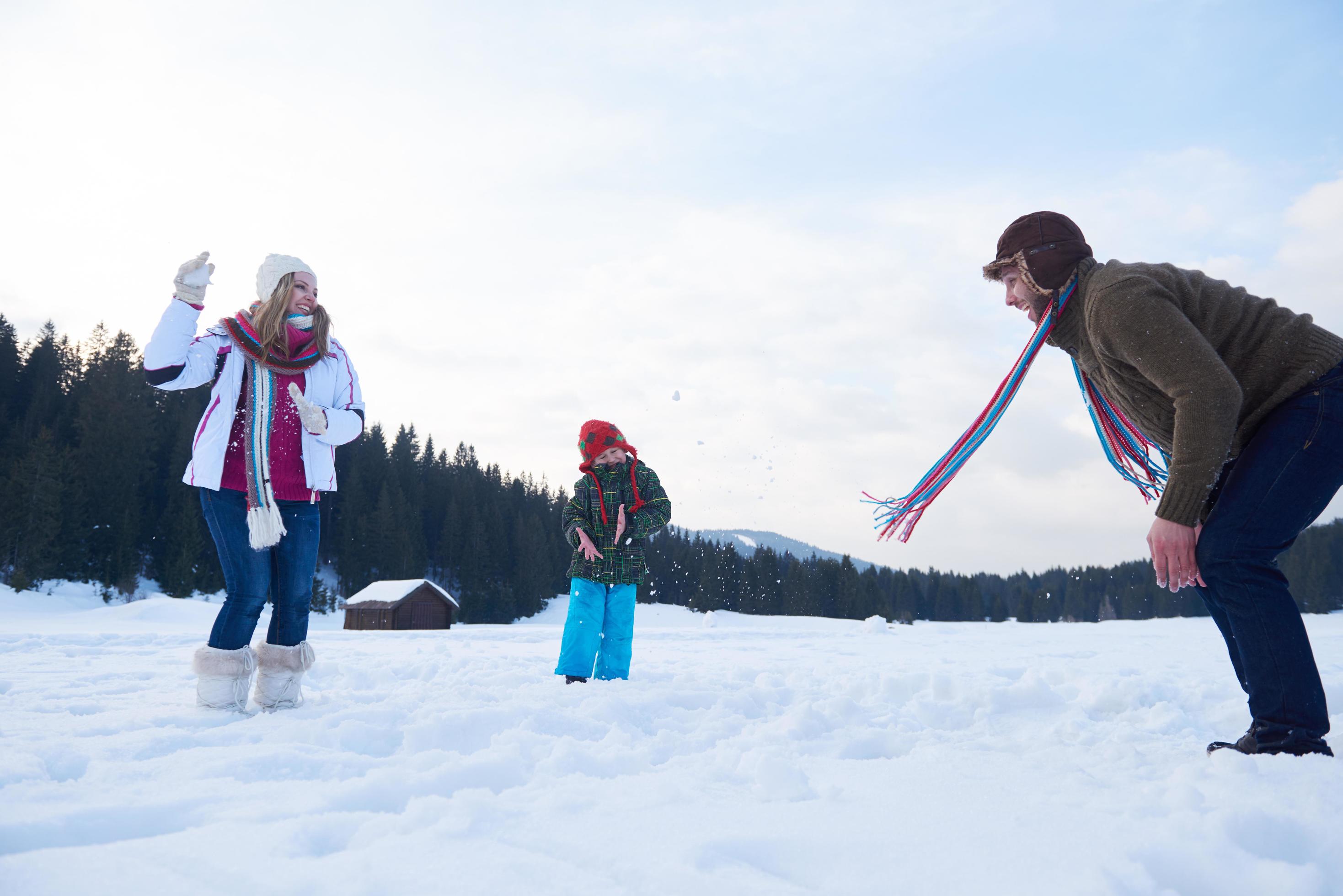 happy family playing together in snow at winter Stock Free