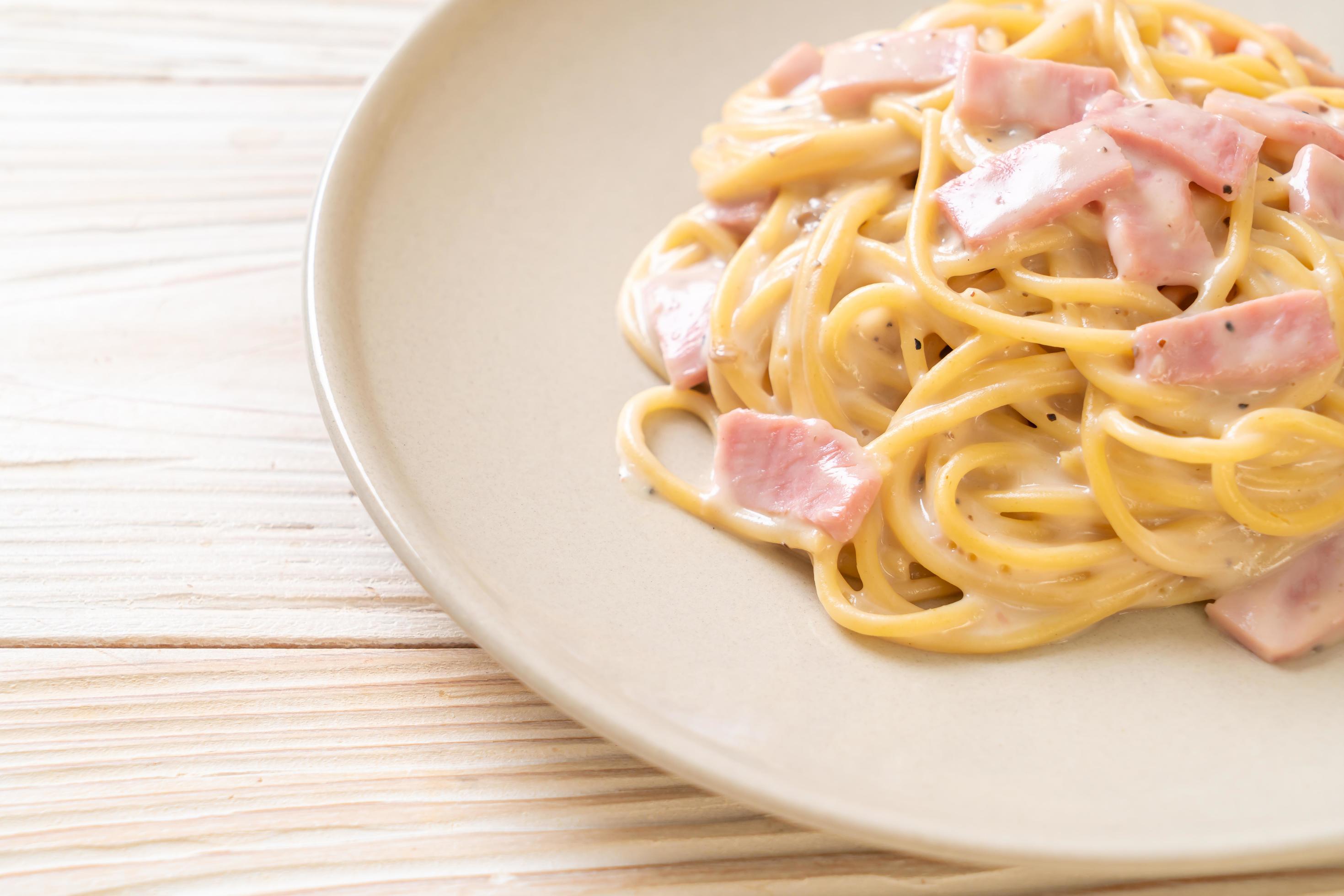 Homemade spaghetti white cream sauce with ham – Italian food style Stock Free