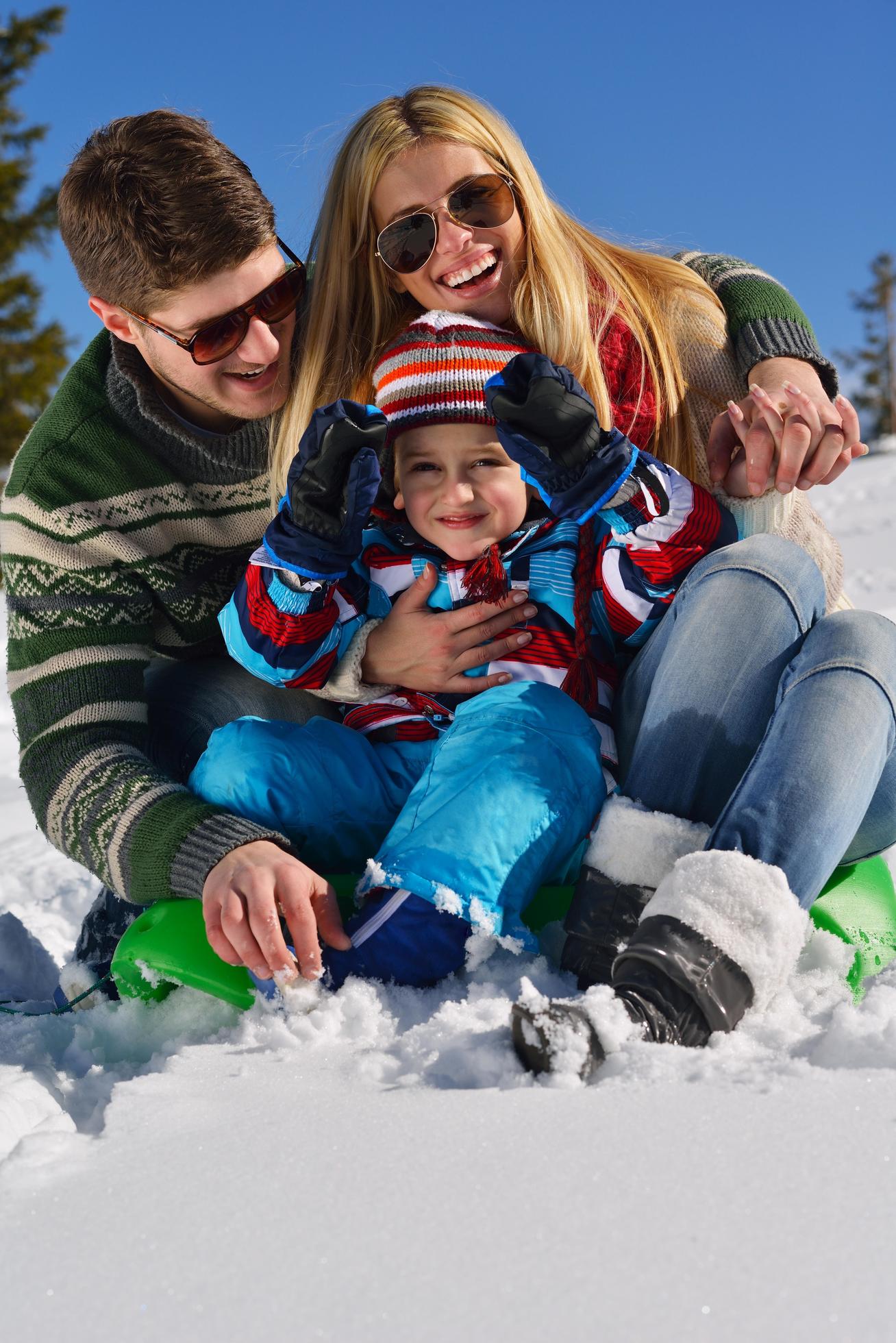 family having fun on fresh snow at winter Stock Free