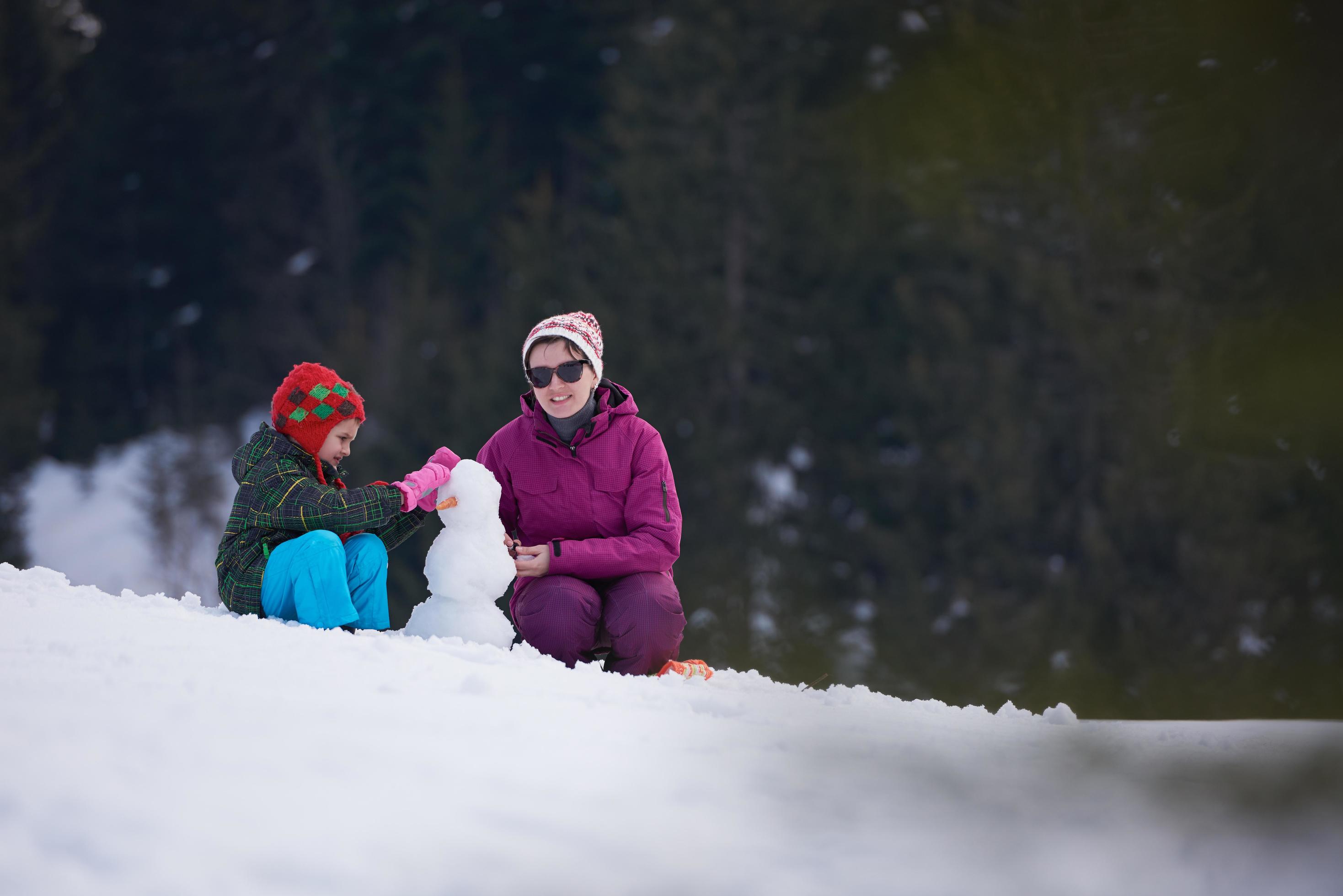 happy family building snowman Stock Free