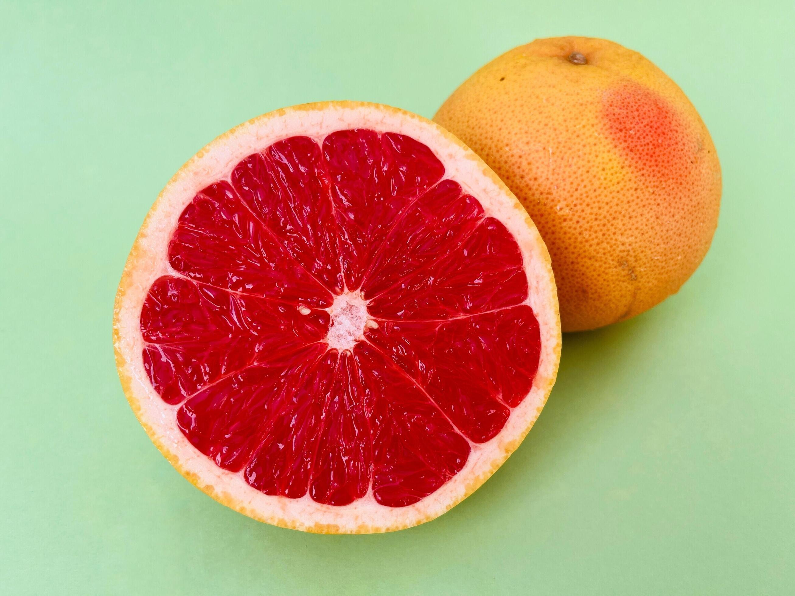 
									Fresh grapefruit fruit. Grapefruit isolated on green background. Grapefruit with clipping path. Stock Free