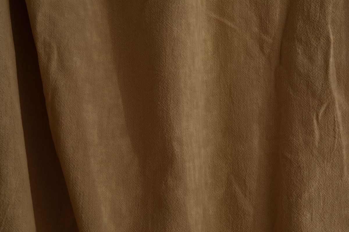 Wrinkled curtain in beige or brown color Stock Free