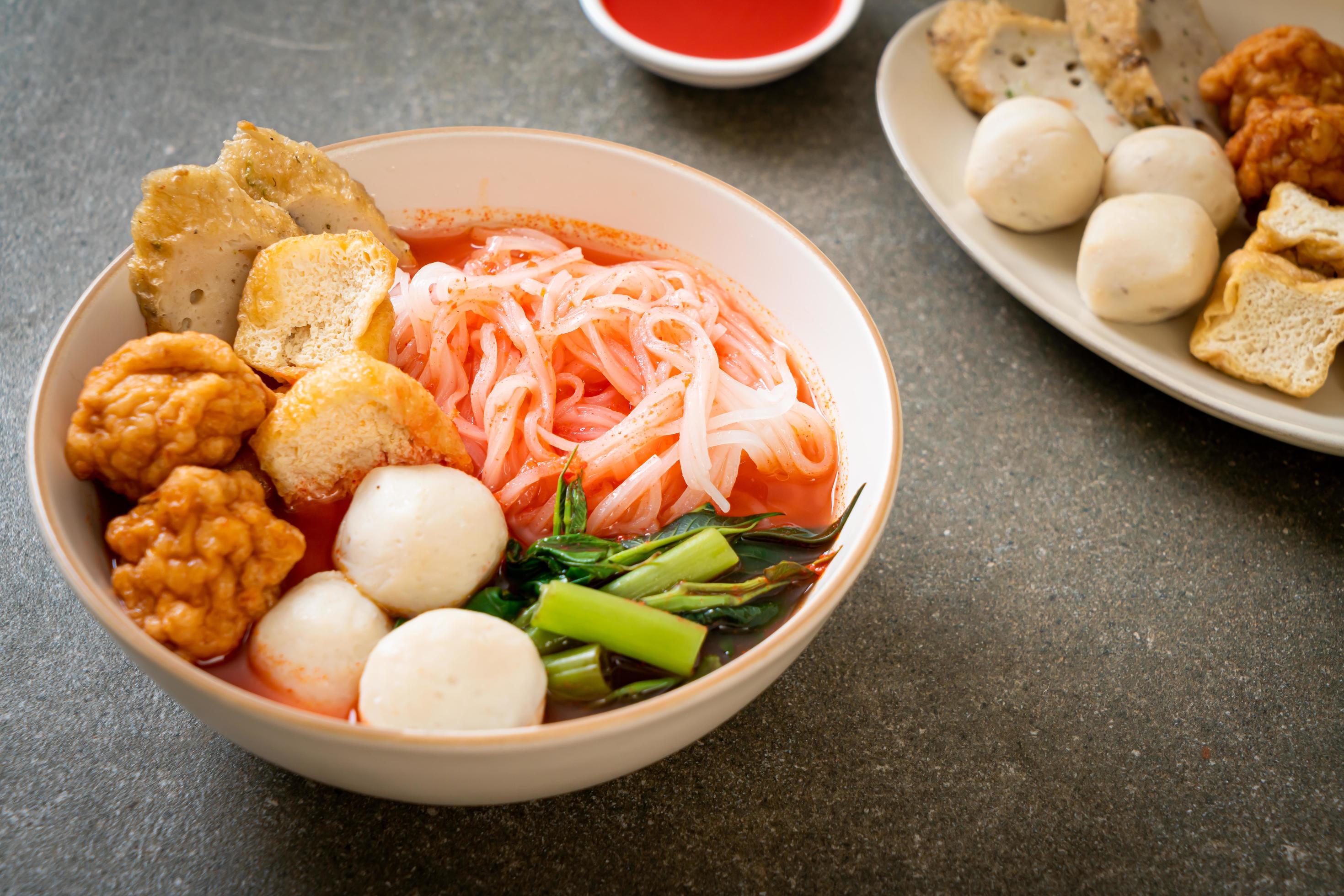 Small flat rice noodles with fish balls and shrimp balls in pink soup, Yen Ta Four or Yen Ta Fo – Asian food style Stock Free