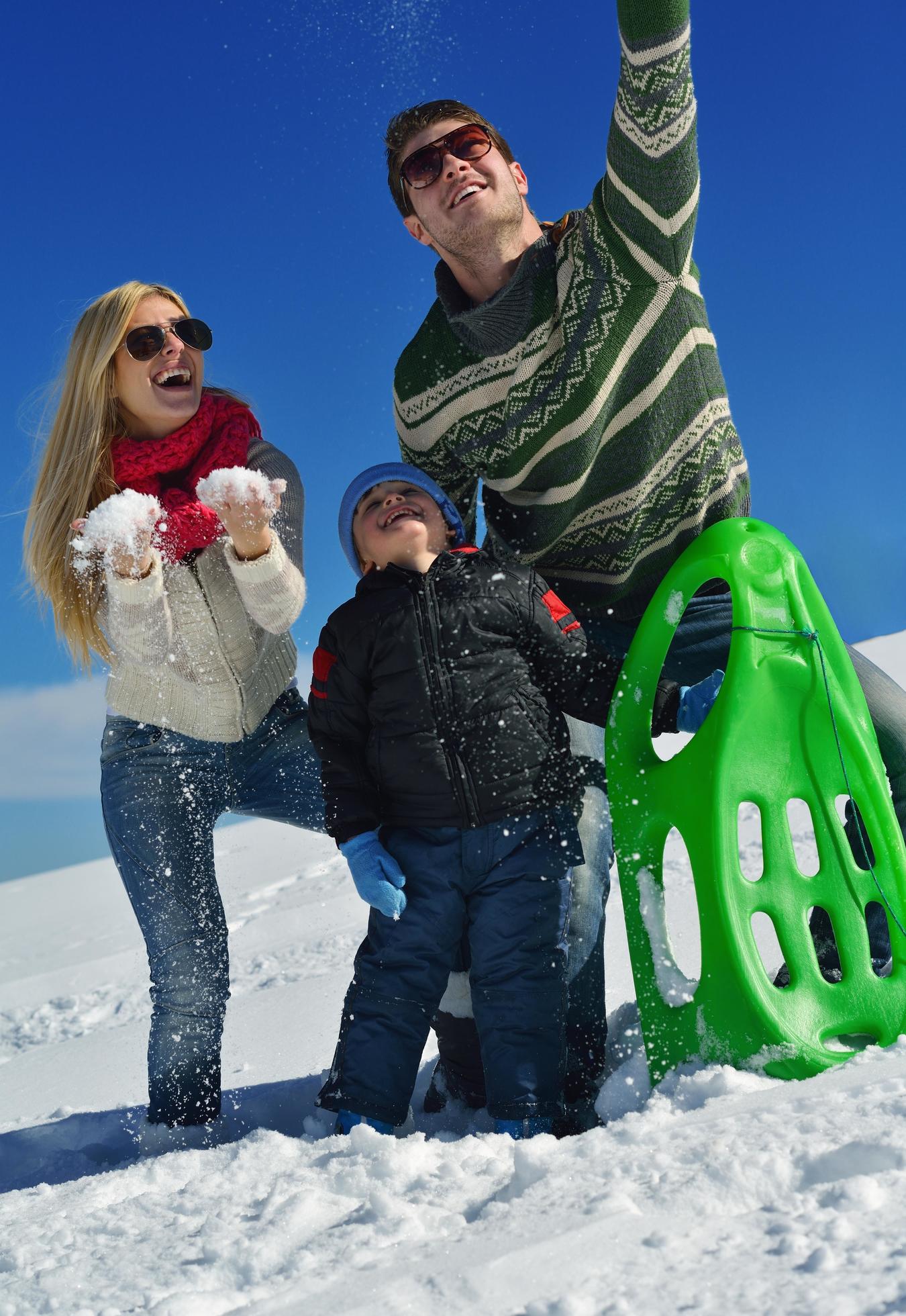 family having fun on fresh snow at winter Stock Free