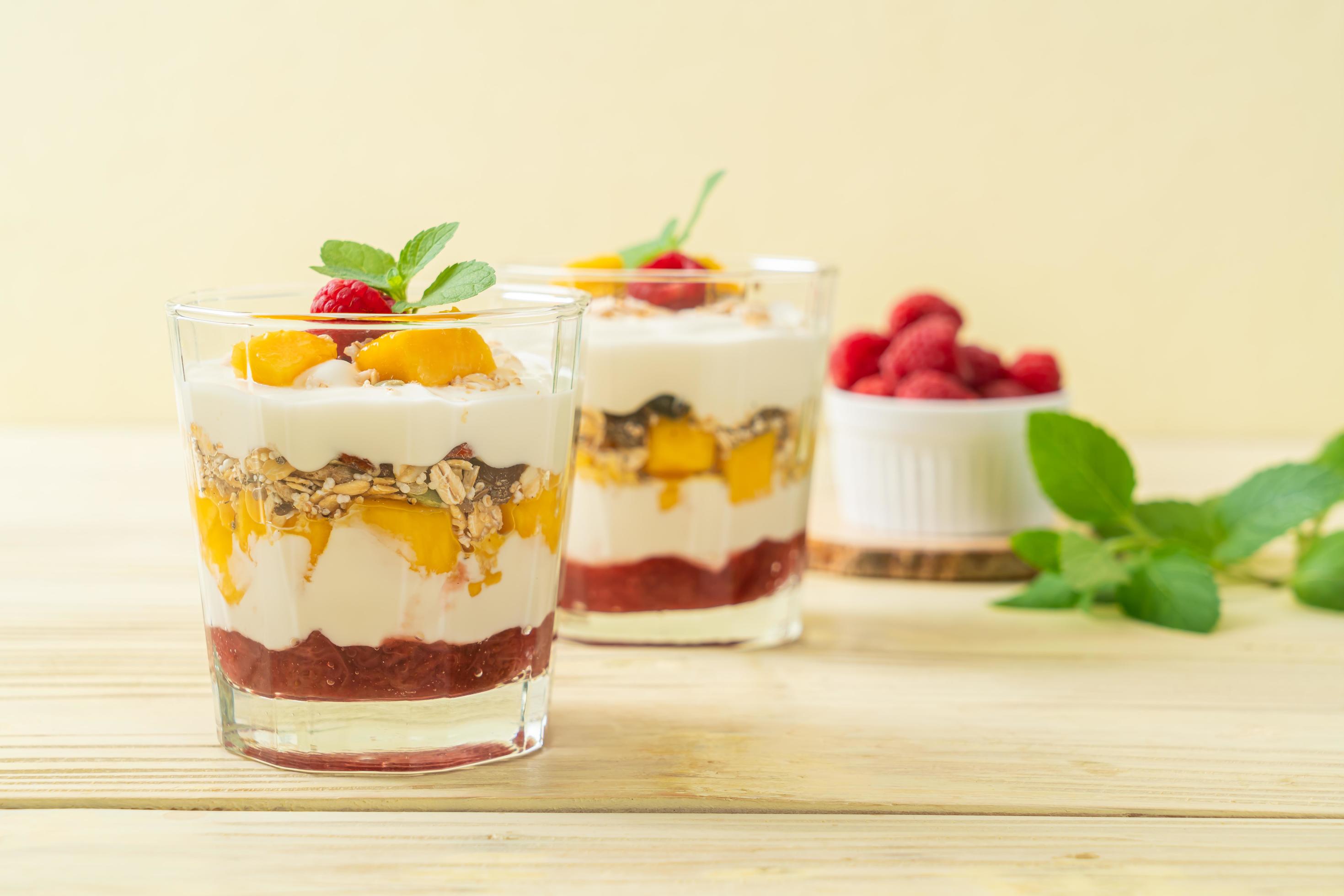 Homemade fresh mango and fresh raspberry with yogurt and granola – healthy food style Stock Free