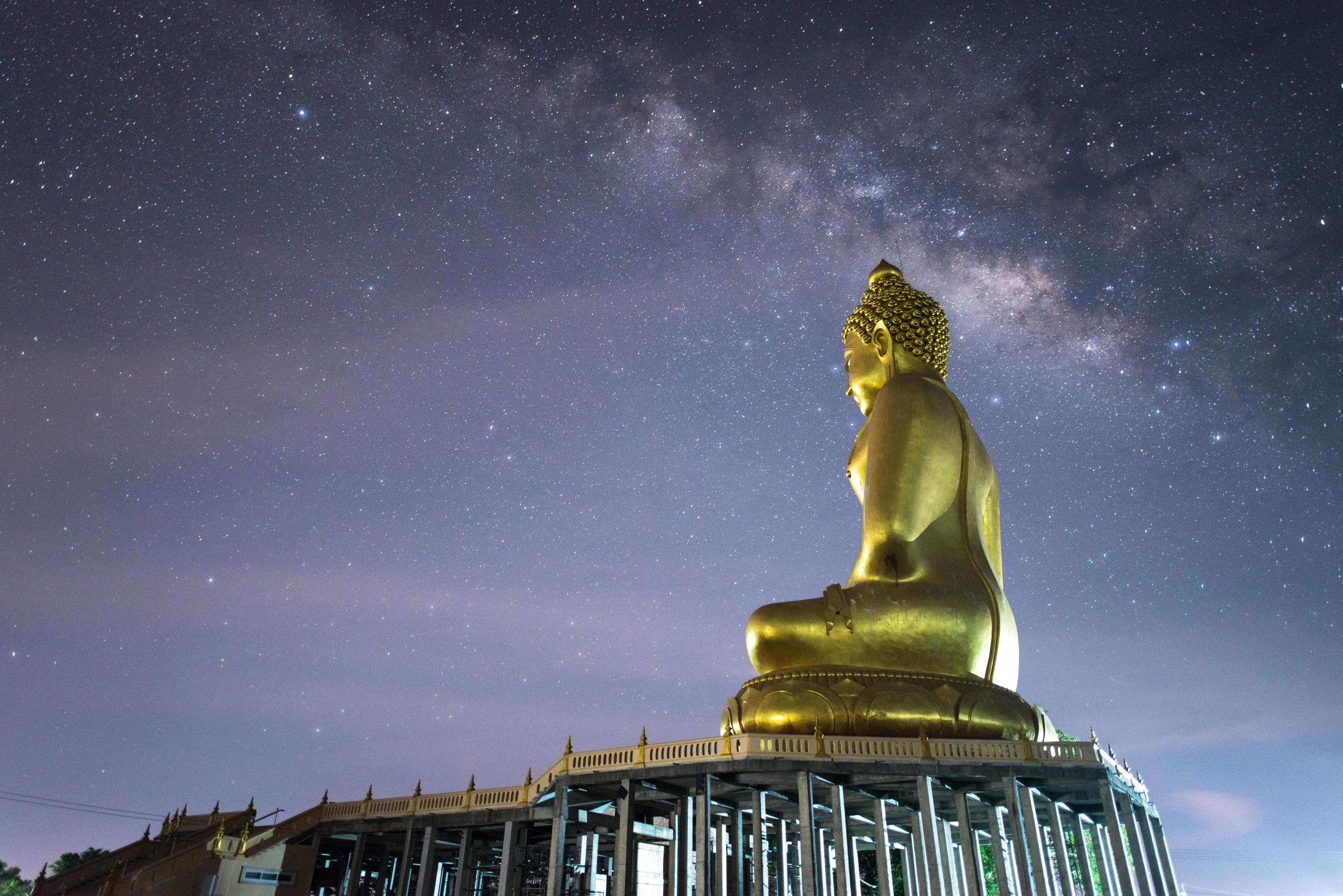 The Milky Way galaxy at the above of big Buddha statue in Phutthamonthon buddhist park in Chiang Rai province of Thailand. Stock Free