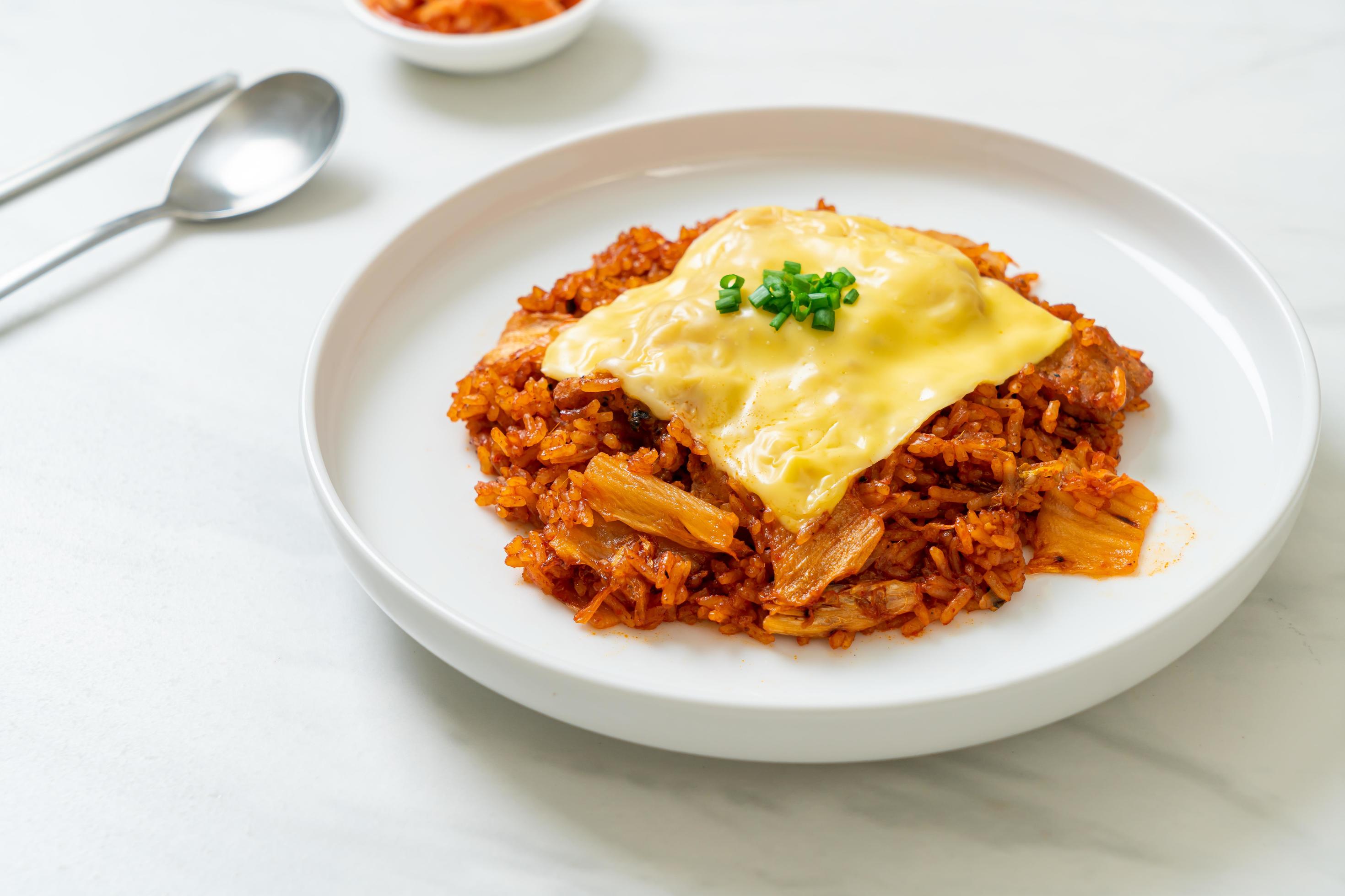 Kimchi fried rice with pork and topped cheese – Asian and fusion food style Stock Free