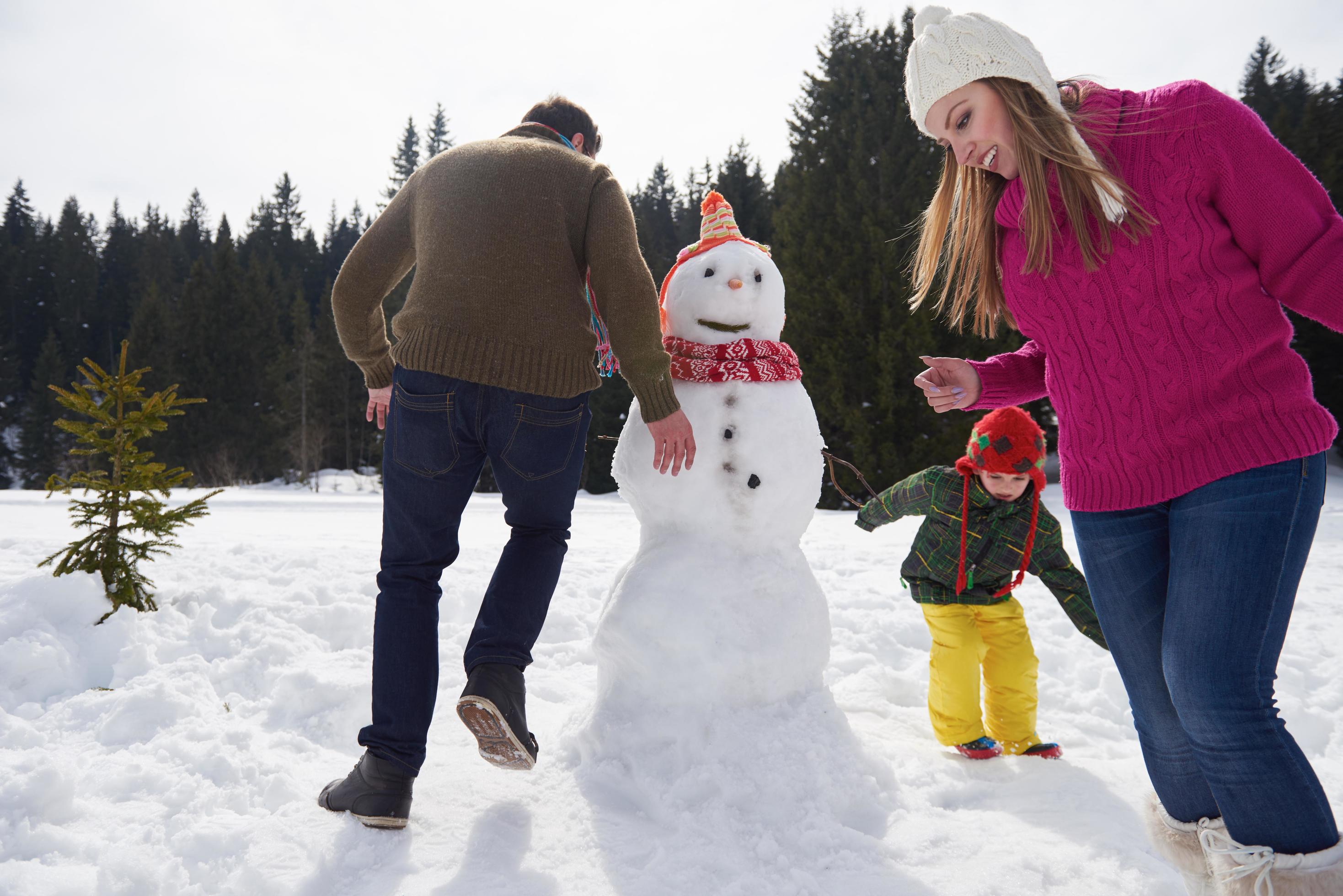 happy family building snowman Stock Free