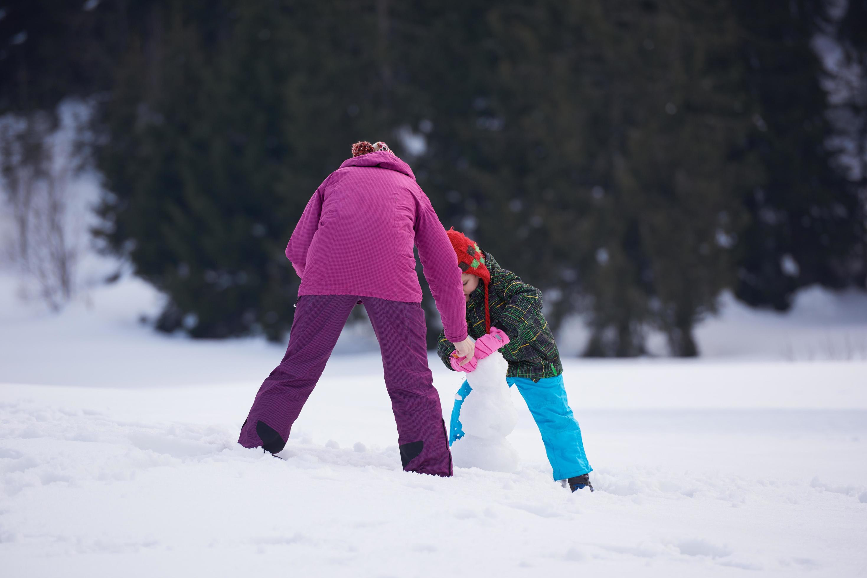 happy family building snowman Stock Free