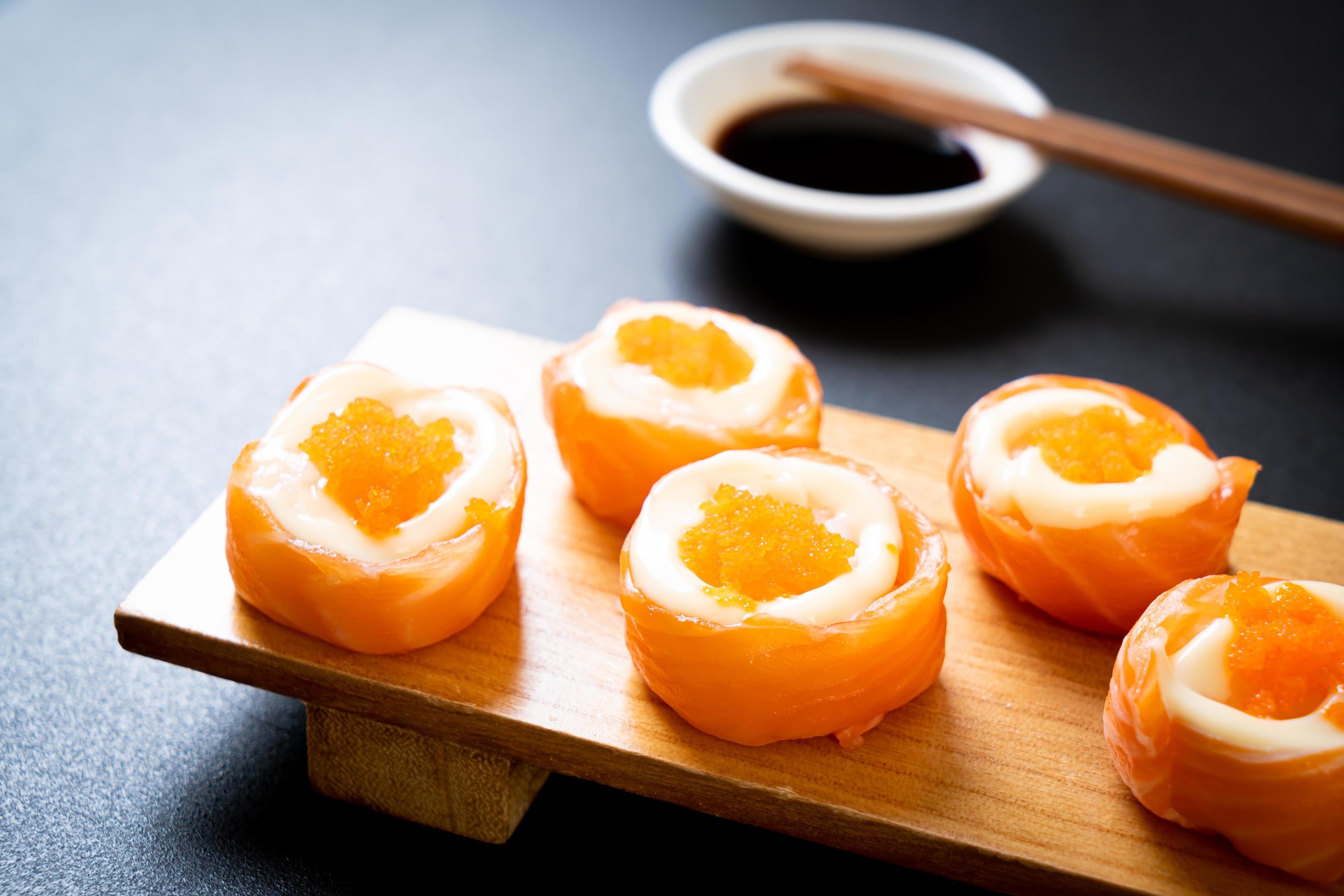 Fresh salmon sushi roll with mayonnaise and shrimp egg – Japanese food style Stock Free