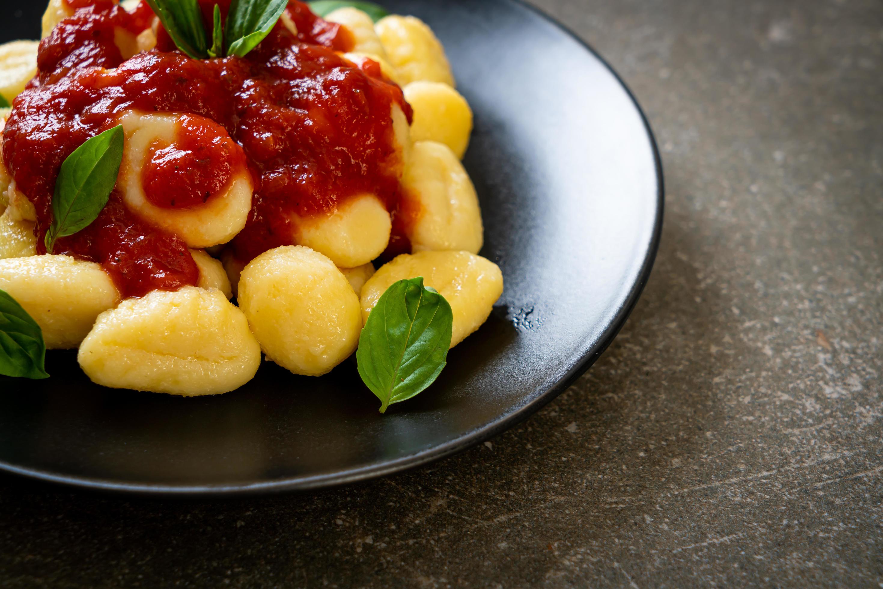 Gnocchi in tomato sauce with cheese – Italian food style Stock Free