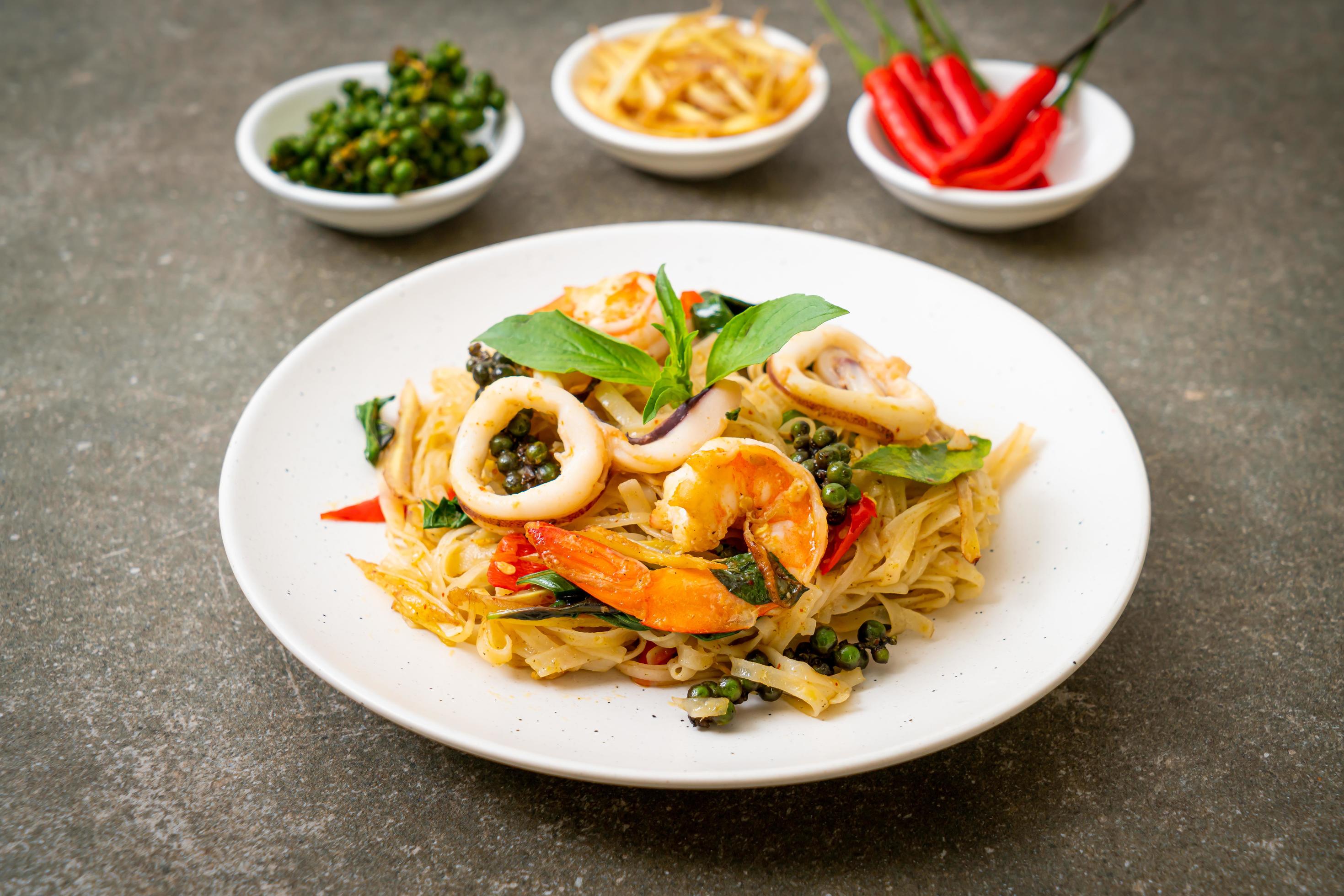 Stir-fried spicy noodles with sea food, or Pad Cha Talay – Thai food style Stock Free