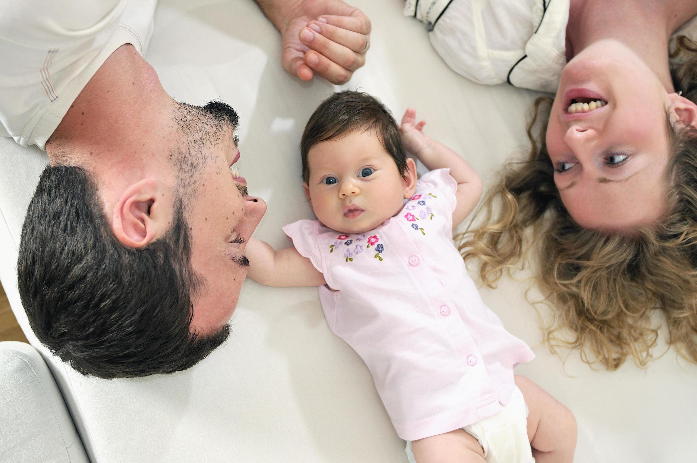 indoor portrait with happy young family and cute little babby Stock Free