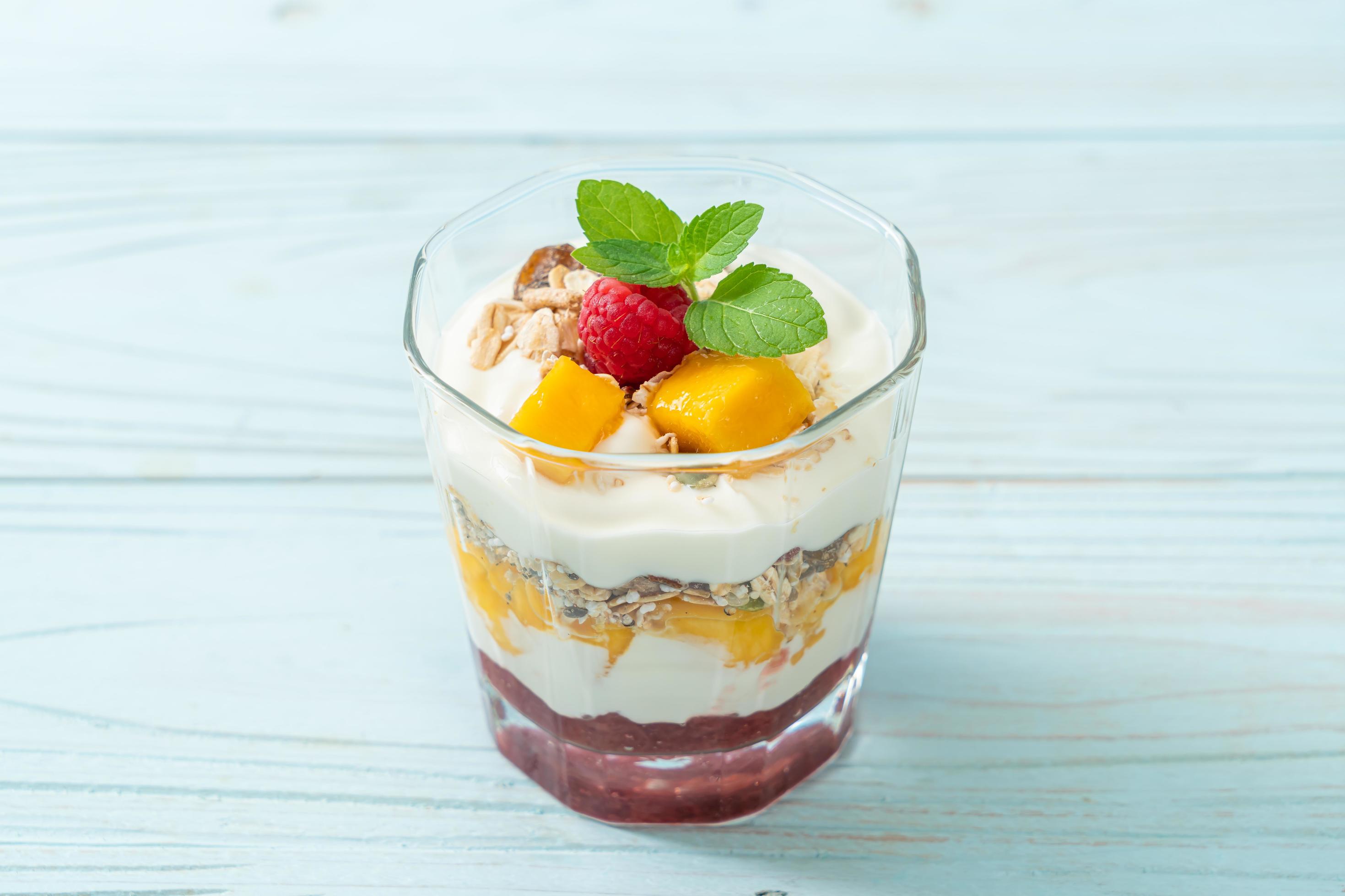 Homemade fresh mango and fresh raspberry with yogurt and granola – healthy food style Stock Free