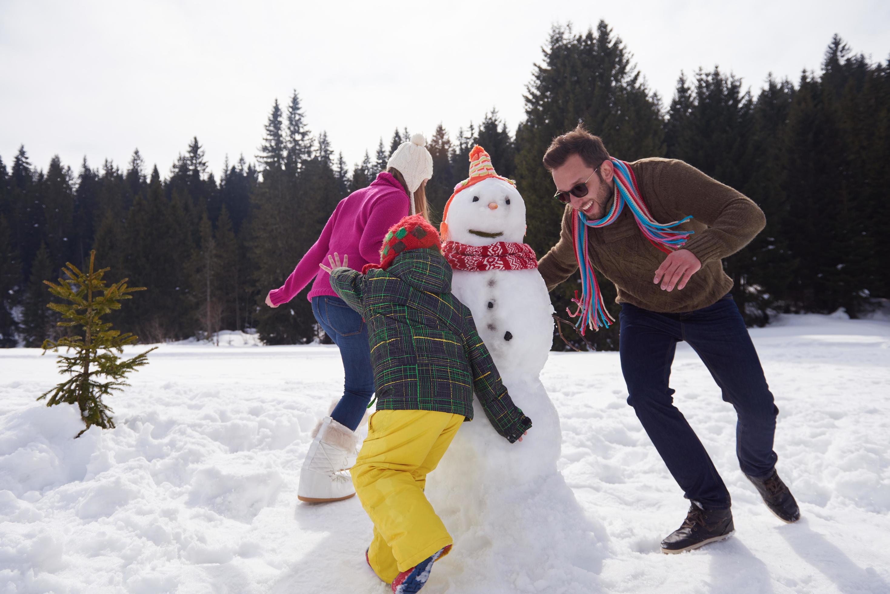 happy family building snowman Stock Free