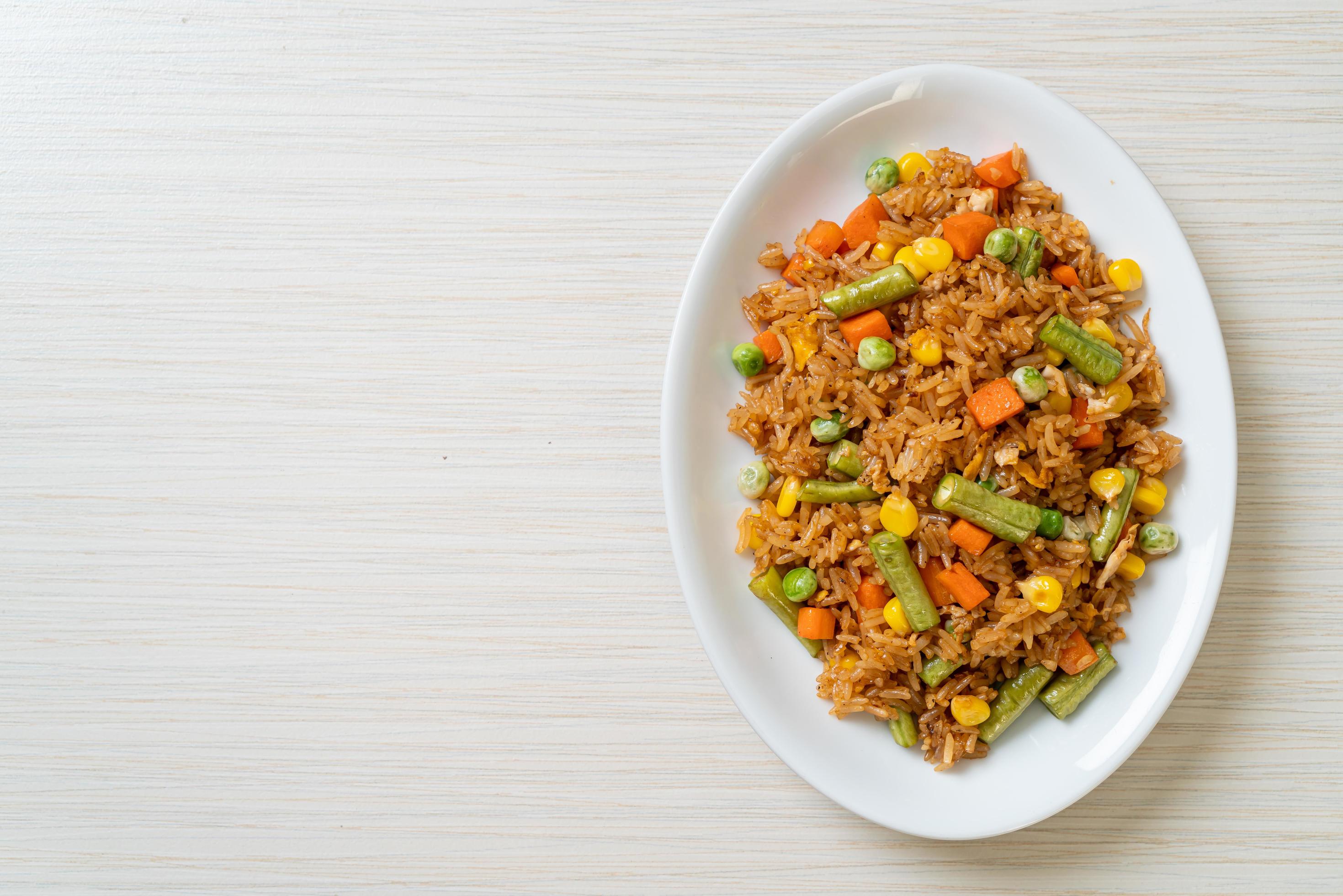 Fried rice with green peas, carrot and corn – vegetarian and healthy food style Stock Free