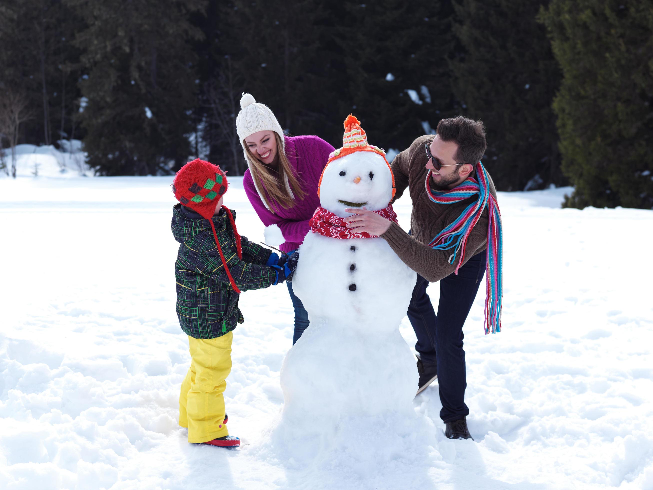 happy family making snowman Stock Free