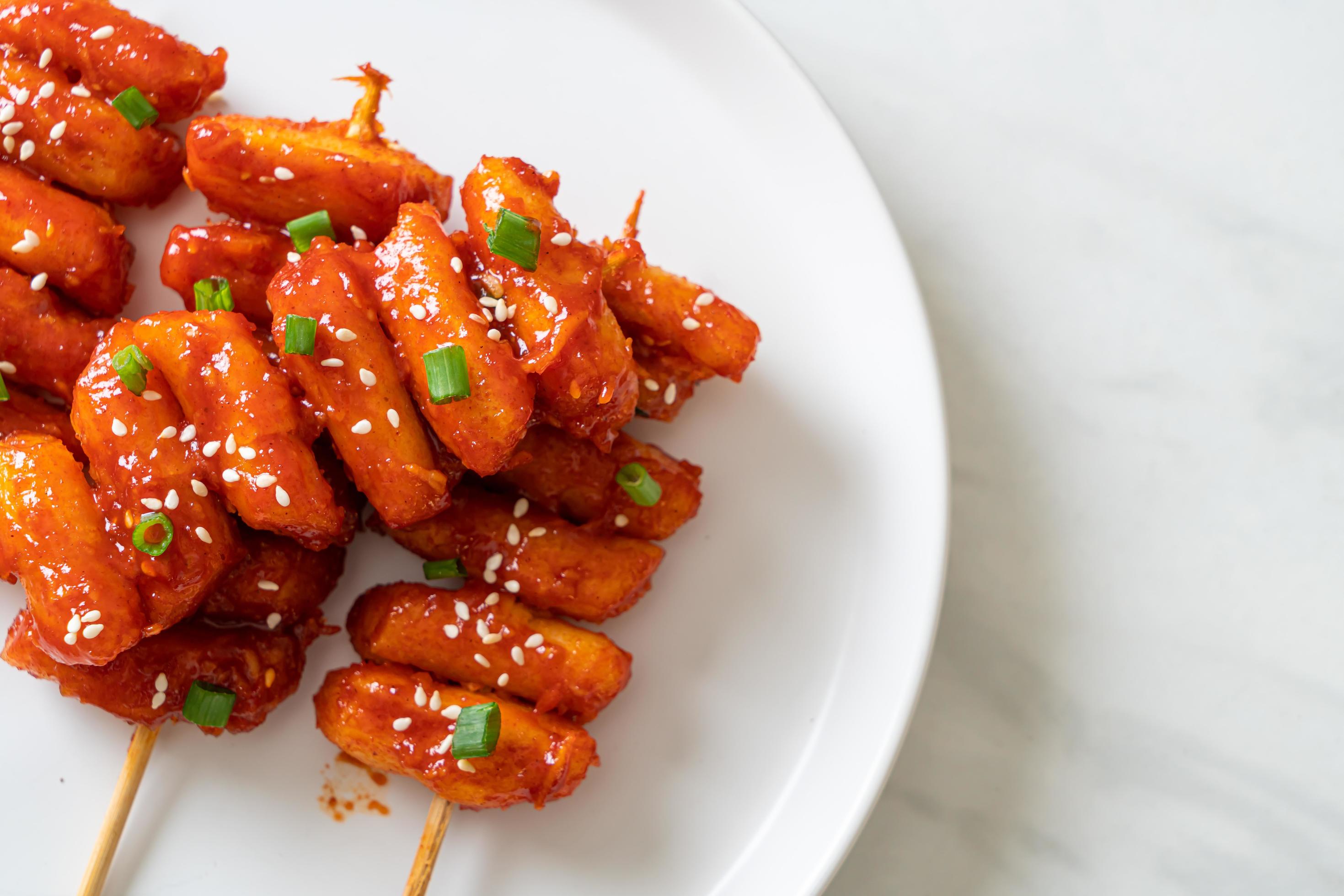 Deep-fried Korean rice cake, or Tteokbokki, skewered with spicy sauce – Korean food style Stock Free